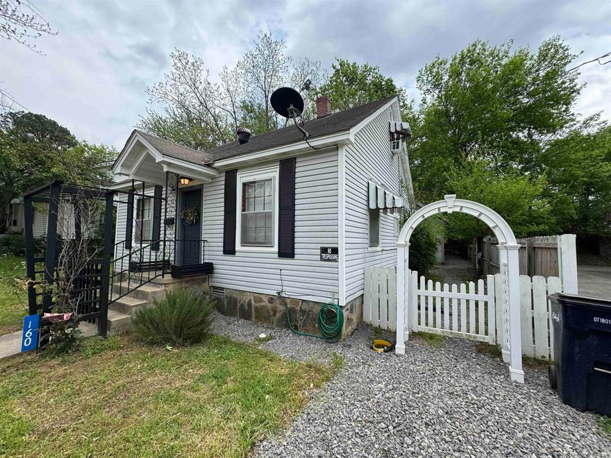 COZY COTTAGE with CURB appeal! The cutest arbor invites you up the walk to this 2 bedroom (possibly 3 bedroom), 1 bathroom home! Step inside to your living room which leads down the hall to the remodeled bathroom with tiled walk in shower! The kitchen has been nicely appointed with new cabinetry and countertops (within last 3 years). You'll find the laundry space in the room leading to the backyard, which could be used as a 2nd downstairs bedroom! Upstairs you'll find another bedroom option complete with closets. The storage building out back gives you space to stash your stuff or finish it out and create a studio, office space, etc! Don't miss out on this nicely freshened up, efficiently laid out home, in a convenient location!