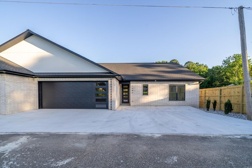 DROPPED BELOW $500K, MOTIVATED SELLER! Welcome to your dream lakefront home on Lake Hamilton! Inside, this home offers an open-concept living area with 11 foot ceilings, along with ample natural light from the large windows throughout the home with views of the water from all angles. Built in 2024, there are modern finishes throughout, which include quartz countertops and backsplash, beautiful CAFE appliances with a built in ice maker, custom cabinets with black and champagne bronze finishes, along with a custom island and built in dining table. Other interior features include upgraded LED lighted mirrors in all bathrooms, tile and glass showers, a separate laundry room, and LVP flooring throughout.  Walk outside onto the large deck with stunning views of Lake Hamilton & the Central Bridge. Just a few steps and you are on the brand new boardwalk to fish, swim, boat. Property is permitted for two PWC docks!  This property also offers an oversized 2 car garage as well as extra concrete for additional parking. All efforts were made to provide this home with a low maintenance exterior so you can spend more time enjoying the lake.