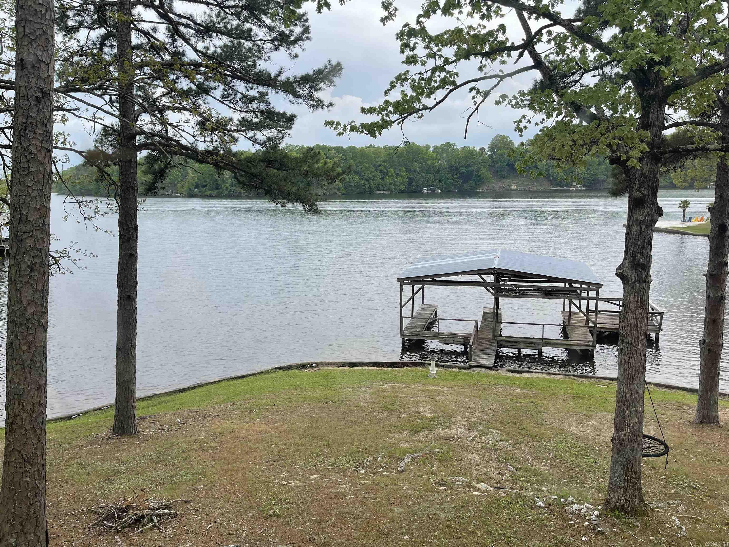 Beautiful view of Lake Norrell. Two houses and an additional one acre lot with pond. All have lake frontage. There is a 2BR 1BA house with approx. 1020 s.f. and the other one is 1BR, 1BA and approx. 520 s.f. Also includes two boat docks. Lots like these are hard to find! Property has not been hooked up to city water and is sold "as is" with no disclosures.