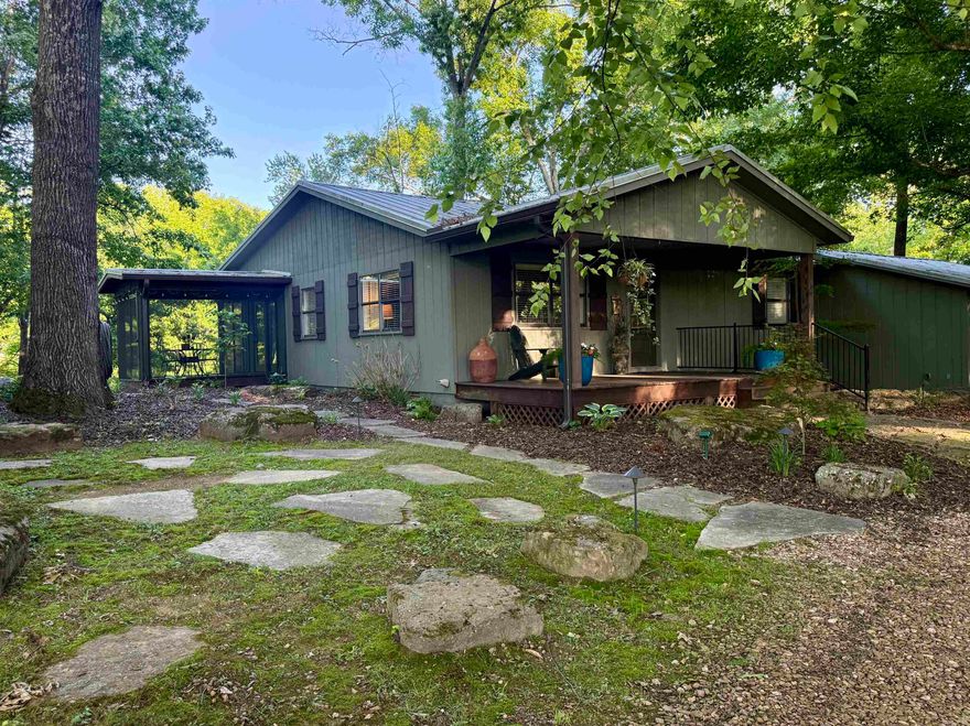 Nestled along the Little Red River, this charming home offers the perfect blend of character, comfort, and thoughtful updates. Featuring 2,449 sq ft, 3 bedrooms, 3 bathrooms, and a dedicated office, this home provides versatile living.  Hardwood floors run throughout, and a recently added primary suite features a vaulted bedroom, river-inspired shower, and large walk-in closet. Picture windows span the back of the home, filling the space with natural light and capturing beautiful river views.  A screened-in porch stretches across the entire back of the home, along with a large deck extending over the river perfect for relaxing or entertaining. The backyard includes rock work designed for beauty and erosion prevention.  Additional features include a hot tub, indoor storage area, separate shop, and underground storm cellar. Ideal for full-time living or a weekend getaway.