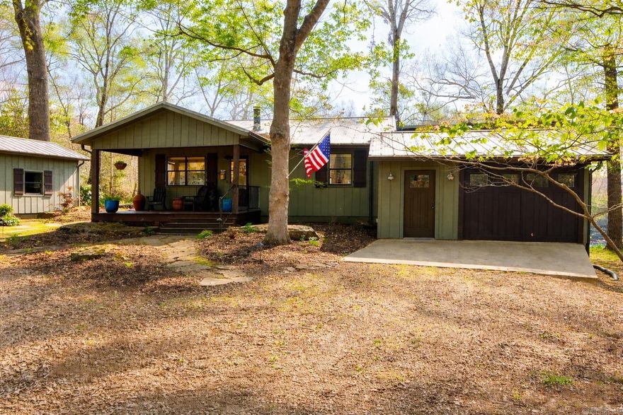 Nestled along the Little Red River, this charming home offers the perfect blend of character, comfort, and thoughtful updates. Featuring 2,449 sq ft, 3 bedrooms, 3 bathrooms, and a dedicated office, this home provides versatile living.  Hardwood floors run throughout, and a recently added primary suite features a vaulted bedroom, river-inspired shower, and large walk-in closet. Picture windows span the back of the home, filling the space with natural light and capturing beautiful river views.  A screened-in porch stretches across the entire back of the home, along with a large deck extending over the river perfect for relaxing or entertaining. The backyard includes rock work designed for beauty and erosion prevention.  Additional features include a hot tub, indoor storage area, separate shop, and underground storm cellar. Ideal for full-time living or a weekend getaway.