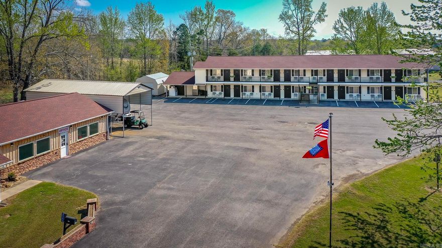 This is a rare opportunity to own a thriving, turnkey hospitality property in the heart of Greers Ferry. Ideally located between The Narrows Bridge and The Edgemont Bridge, this well-established 16-room motel attracts steady business from fishermen, boaters, and lake travelers who return for its convenience and proximity to the water. Shiloh Marina, Lacey’s Marina, and Devil’s Fork Park Boat Ramp are just minutes away. The motel offers approximately 5,424 sq ft of updated guest space, including 2 king rooms and 14 double queen rooms. All rooms have been refreshed, including energy-efficient LED lighting. Furnishings, appliances, and motel equipment convey. Recent upgrades include new tankless gas water heaters installed in 2025. The motel operates primarily on electric, with gas used only for water heaters and two commercial dryers, and has its own septic system. A separate 3BR/2BA home offers approx. 1,560 sq ft, a fenced backyard, major appliances, and a long-term tenant who wishes to stay. A 14x24 storage building and easy boat parking add value. This well-maintained property offers strong income and long-term potential.