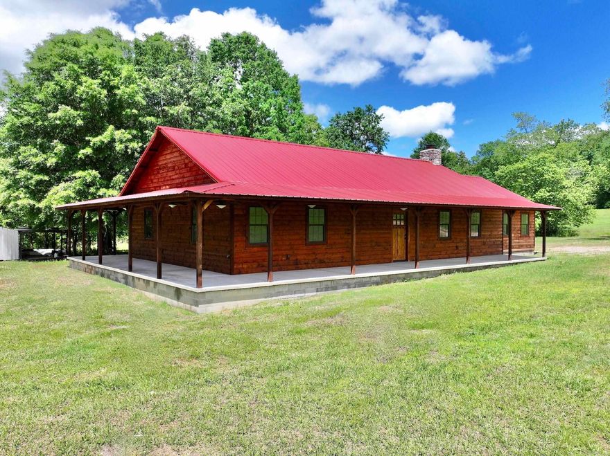 Nestled in a serene countryside on 20± acres, this charming ranch-style residence boasts a rustic wood exterior complemented by inviting wrap-around porches. Tucked away from the bustling road, yet conveniently accessible from the highway, it offers a perfect blend of tranquility and convenience. Step inside to discover a meticulously crafted open-concept living space adorned with a striking rock fireplace, creating a cozy ambiance for relaxation. The residence features three spacious bedrooms, two well-appointed bathrooms, and ample storage with large closets throughout. The primary bedroom is a sanctuary of comfort, complete with a generous walk-in closet and a luxurious ensuite bathroom featuring a walk-in shower. Throughout the home, the warmth of wood accents the walls and vaulted ceilings, adding to its timeless appeal. The perfect home to rest, relax, and embrace rural living.