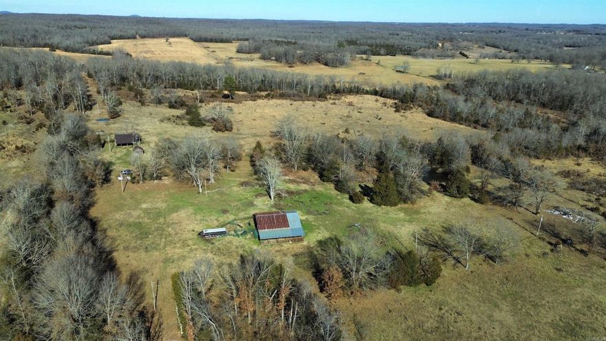 Located in the rural countryside of Arkansas, this 124 acre property offers the perfect blend of privacy, natural beauty, and agricultural potential.   Designed with cattle farming in mind, the property is equipped with a barn, cattle working pen, fenced areas, rolling hills, and grazing pastures, giving you the potential for a thriving cattle infrastructure. In addition, a meandering creek and two ponds add a valuable water source for your cattle.  Hunting enthusiasts will appreciate the property’s diverse range of wildlife, including dove, hogs, quail, turkey, and whitetail deer.   You'll also find a 2 bedroom, 1 bathroom, 933 square foot fixer-upper home awaiting your personal touch. With a little imagination and TLC, it has the potential to be the perfect farmhouse retreat. This house is your blank canvas for endless customization possibilities. Well water and electricity are readily available.  This is more than just land; it's an opportunity to create a legacy and embrace the country lifestyle. Whether you're an aspiring farmer, nature lover, hunting enthusiast, or someone seeking a peaceful retreat, this property offers so many lifestyle options, all for $395,000!