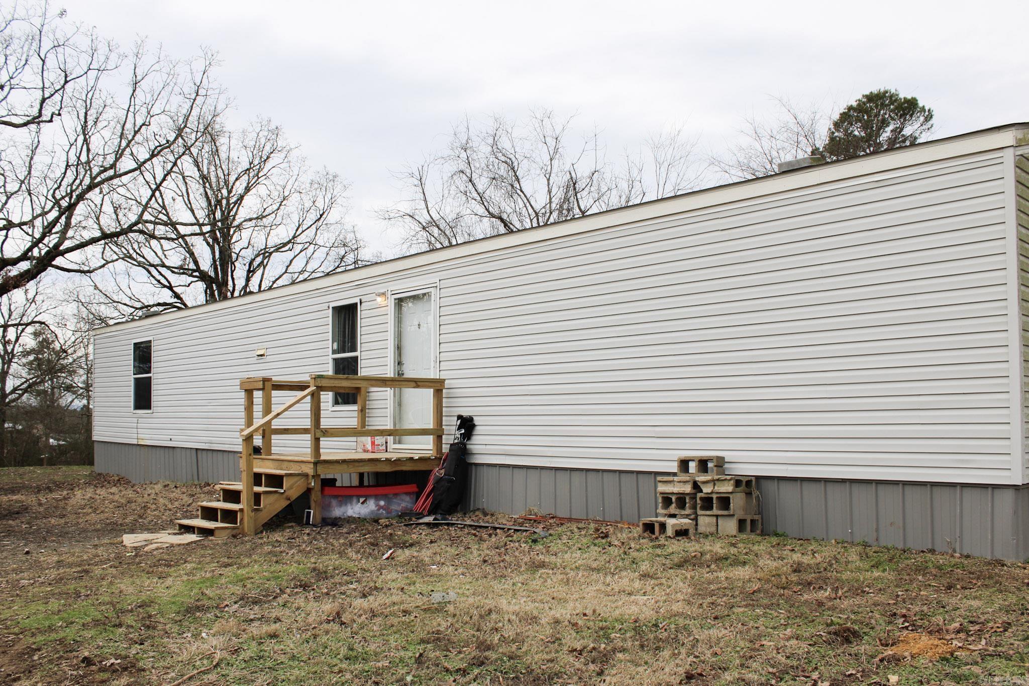 MOTIVATED SELLER. Mobile home on 5 acres m/l in a quiet country setting out of city limits. This property has been recently cleared to provide a large yard for any outdoor activity! It is located on a quiet county road not far from Menaās amenities. The 2019 mobile home features 3 bedrooms and 2 bathrooms with a spacious dining/living room combo. There is plenty of room for a large garden or a small homestead.