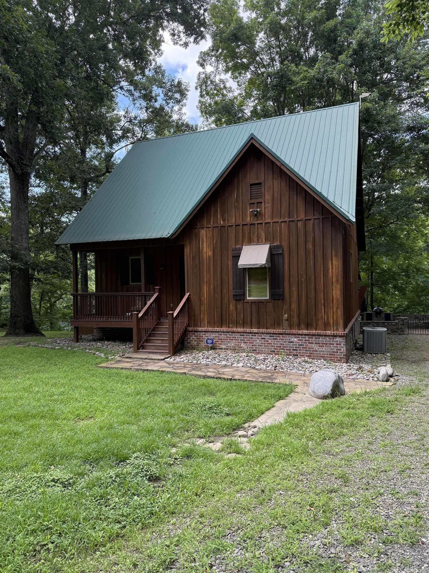Here's your river house--perched on the banks of the Little Red River, famous for some of the best trout fishing in North America. 3 bed, 2.5 bath with pure rustic charm and modern comfort. Great outdoor spaces including multiple decks and rock work, built-in Big Green Egg and a dock with mechanical boat lift. Pine plank floors in the great room, gas log fireplace, heavy beamed ceilings complete the look and feel. Minutes from spectacular Greers Ferry Lake, shopping and services in Heber Springs. Furnishings and appliances convey, just bring your groceries and fly rod!