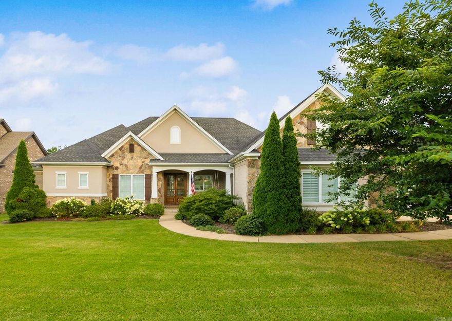 STUNNING LAKEFRONT RETREAT WITH PANORAMIC VIEWS & LUXURY POOL! Expansive back porch with east facing view flows to a spacious patio with gunite pool, which has water fountains and a Wi-Fi-enabled pump. The yard is fully fenced and a cozy fire-pit at the water’s edge is great for chilly nights. Inside, enjoy an open chef’s kitchen with gas range, double ovens, and wine fridge that opens to living room with 12-ft ceiling, gas fireplace, and gorgeous lake views. The private primary suite overlooking lake offers an office, dual vanities, and a walk-in closet that doubles as a safe room. 3 other bedrooms on main level including in-law suite with hardwood floors and water views. Upstairs is a bonus room or 5th bedroom with bathroom featuring a newly installed custom tile shower. Upgrades and updates include plantation shutters, automated shades, iron fencing, sprinkler system, safe room, gas hook up for grill, new carpet, fresh paint, and a whole-home generator—making this property as practical as it is spectacular. Won’t last long!
