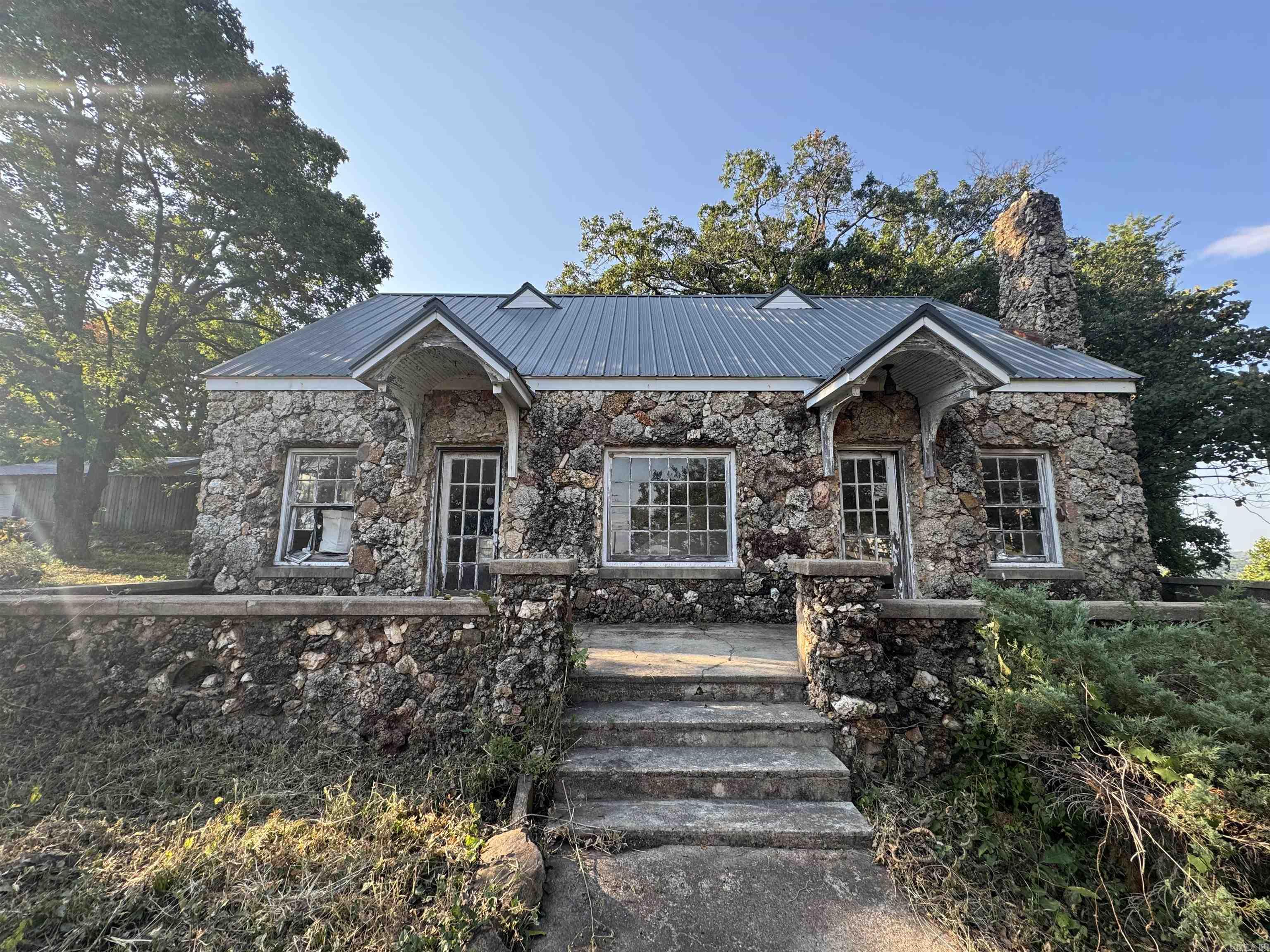 Here's your chance to BREATHE NEW LIFE into a local landmark! The truly one of a kind rock house at the top of the mountain awaits new owners with a VISION! With a beautiful view of the White River Valley and a convenient location, this home could be restored for residential or a quaint bed and breakfast or Airbnb rental! Or with the high visibility from both Batesville Boulevard and Heber Springs Road, this might offer you the PERFECT location for your next business venture (would require rezoning)- antique store, boutique, day spa or salon with a vibe, restaurant, the options are endless! Home will not qualify for mortgage lending (FHA, RD, USDA-RD, Conventional) and is being sold in ''as is'' condition.