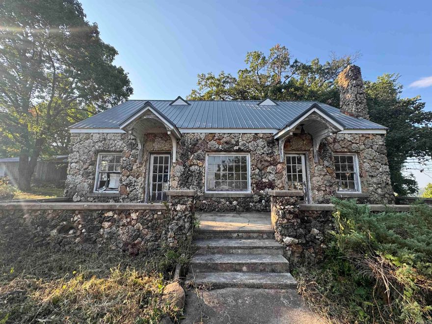 Here's your chance to BREATHE NEW LIFE into a local landmark!  The truly one of a kind rock house at the top of the mountain awaits new owners with a VISION!  With a beautiful view of the White River Valley and a convenient location, this home could be restored for residential or a quaint bed and breakfast or Airbnb rental! Or with the high visibility from both Batesville Boulevard and Heber Springs Road, this might offer you the PERFECT location for your next business venture (would require rezoning)- antique store, boutique, day spa or salon with a vibe, restaurant, the options are endless!  Home will not qualify for mortgage lending (FHA, RD, USDA-RD, Conventional) and is being sold in ''as is'' condition.