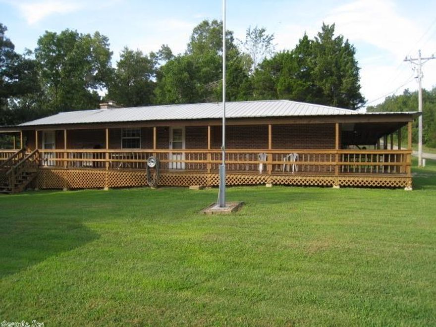 COZY, COMFORTABLE and WELL MAINTAINED describes this 2-BR/1-BA  BRICK HOME. Nice and bright kitchen with plenty of cabinets,  good sized master BR.  CH/A, metal roof and windows ONLY 5 YRS. OLD.  PLUS...you will love the covered wrap-around deck for grilling and outside living.  Extra nice 30 x 40 workshop that is  complete with work benches, storage area and all the things a shop would need.  Only a short distance to a beautiful private lake and marina for boating, fishing and swimming.   COME SEE!!