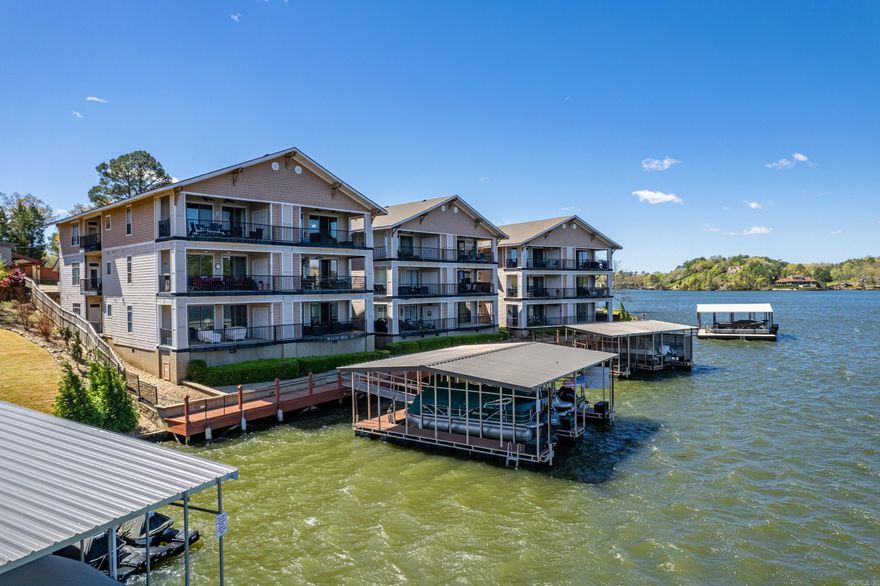 Welcome to this waterfront condo situated in a gated community, offering privacy and security. This 1st floor 2-bedroom, 2-bathroom condominium features a spacious and open layout with large windows overlooking Lake Hamilton. The kitchen boasts a large island, granite countertops, and stainless steel appliances, making it a perfect place to entertain. The living room is highlighted by a cozy fireplace, perfect for relaxing and unwinding. Step outside to the private balcony overlooking the serene lake and enjoy the water views. Residents can also take advantage of the community pool. Located in a prime waterfront location, this condo is an ideal retreat for those seeking waterfront living in a peaceful and picturesque setting. Don't miss this opportunity to make it your home!  **Approved for a VA Loan Guaranty**
