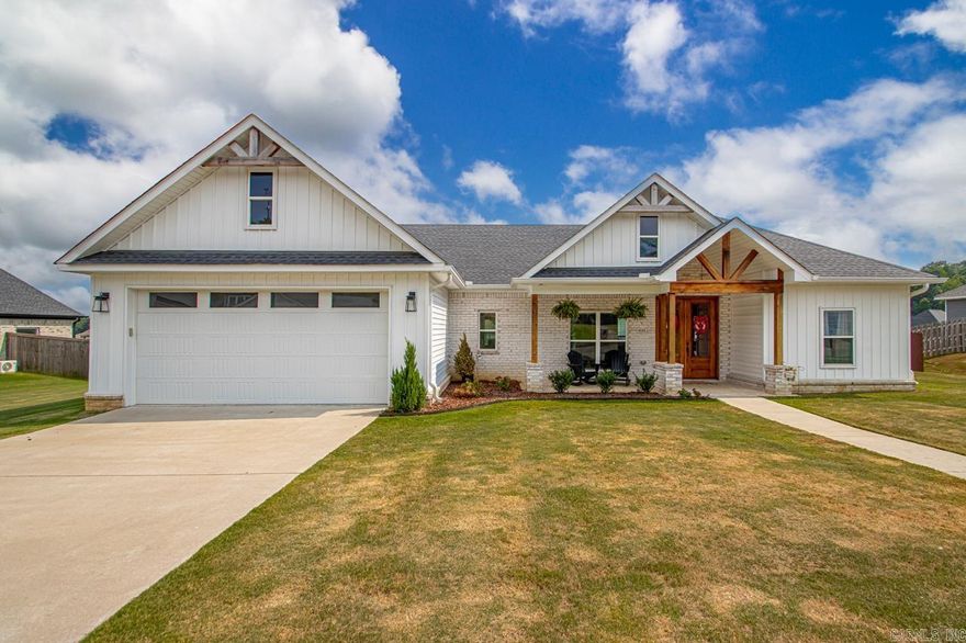 Welcome to this warm and inviting home in the highly sought-after Crossroads Village neighborhood. With 4 bedrooms, 2 bathrooms, and over 2,200 square feet of thoughtfully designed living space, there’s plenty of room for everyone to live, work, and unwind.  Enjoy the charming front porch—perfect for sipping coffee and enjoying a quiet moment. Inside, the spacious living room is filled with natural light and features a cozy gas fireplace. The kitchen is both functional and beautiful, complete with stainless steel appliances, a pantry, modern cabinetry, and large kitchen island, perfect for everyday meals!  The primary suite is your own private retreat with a large bedroom, walk-in closet, soaking tub, and walk-in shower. A full laundry room adds extra convenience to your daily routine.  Step outside to enjoy nearly half an acre of fenced-in yard with a covered patio—ideal for cookouts, kids and pets, or just soaking in the outdoors. The attached two-car garage provides plenty of space for parking and storage.  This home truly has it all—space, comfort, and a great location in Saline County. Schedule a showing today!