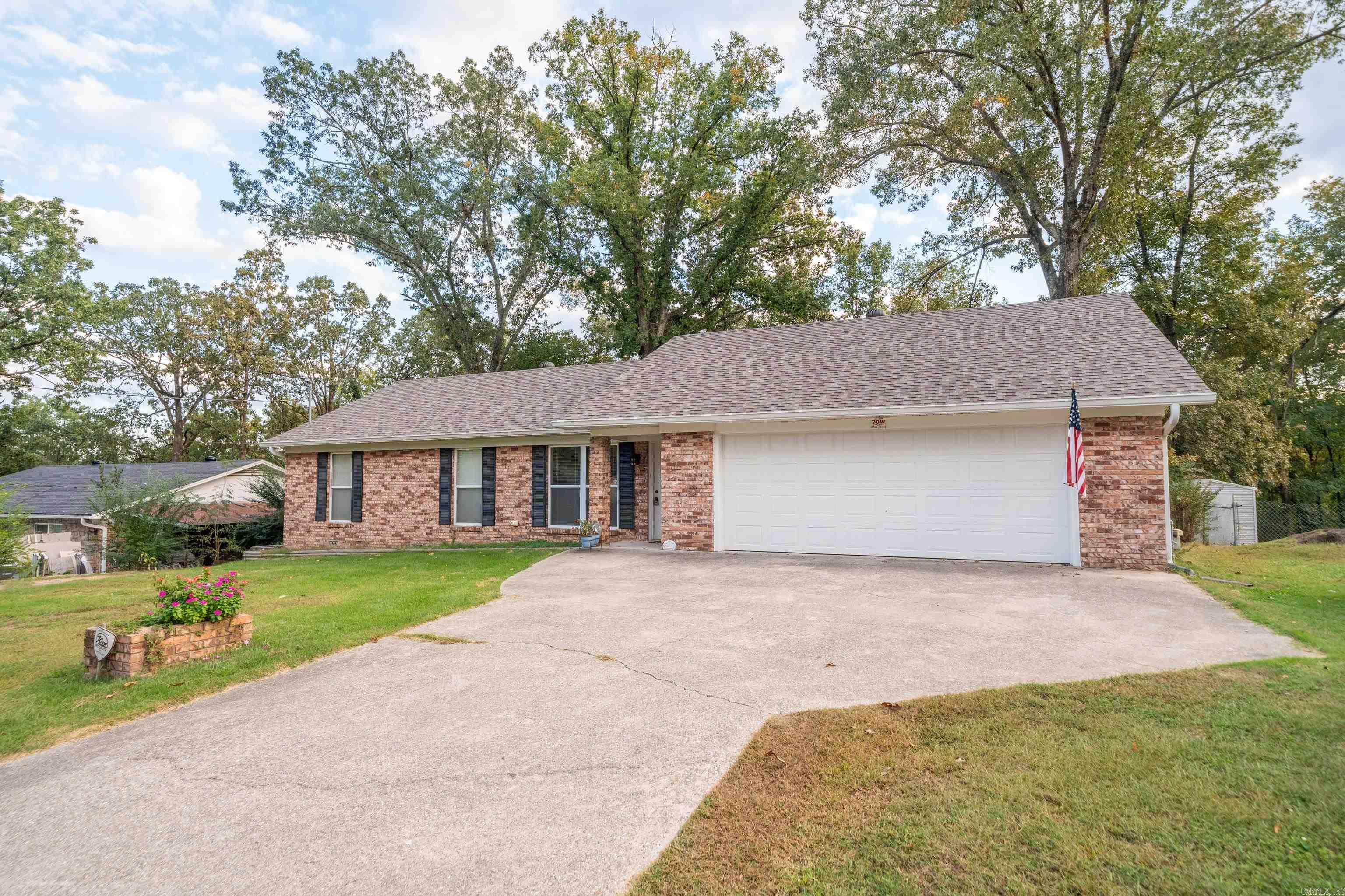 Charming 3-Bedroom, 3-Bath Brick Home in Lake Hamilton School District! Welcome to this spacious and well-maintained brick home nestled in the desirable Lake Hamilton School District. Boasting 3 bedrooms and 3 full bathrooms, this home offers a unique layout featuring two master suites, perfect for multi-generational living or guest accommodations. One of the master suites includes a  jetted tub and separate shower for ultimate relaxation. Enjoy plenty of room to spread out with two living areas and a large den complete with a cozy fireplace insert and blowers, ideal for cool evenings and family gatherings. The kitchen and dining flow seamlessly into the living spaces, making entertaining a breeze. Step outside to a covered back patio overlooking the spacious backyardāperfect for kids, pets, and outdoor fun. Two storage buildings provide ample room for tools, hobbies, or seasonal items. Additional features include a 2-car garage, new HVAC system, and great curb appeal with a classic brick exterior. This home truly offers the comfort, space, and convenience today's buyers are looking for. Donāt miss the opportunity to make this versatile and inviting property your new home!