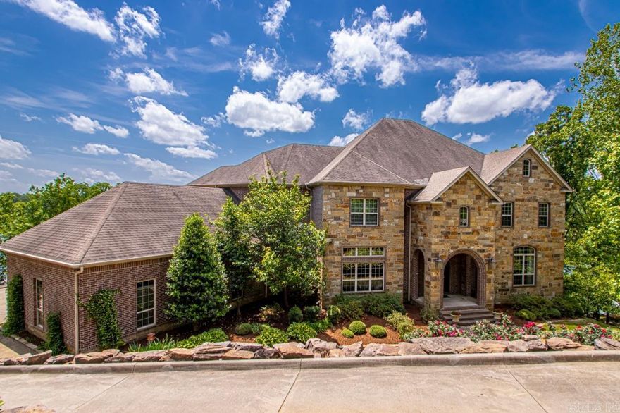 Fabulous estate nestled along the tranquil shores of Lake #1 in the highly desirable Lakewood neighborhood. This masterfully custom designed stone & brick home offers a harmonious blend of elegance & comfort. Inside you will find a 2-story foyer, large formal dining with butler’s pantry, open concept gourmet kitchen with breakfast nook, and family room with incredible views of the lake. Also on the main level, find an enchanting 2 story office/library room, & private guest suite with sitting room. The four bedrooms upstairs include the spacious primary suite & luxury spa inspired bathroom with two walk-in closets. The lower level features an additional living space/game room with wet bar, separate workout room, music room, theater, and a sauna! Plentiful storage throughout on every level. The outdoor living space is a private oasis with breathtaking lake views and pool. The 3-car side loading garage, lush landscaping on .90 acres, and private cul de sac make this stunning property such a rare find.