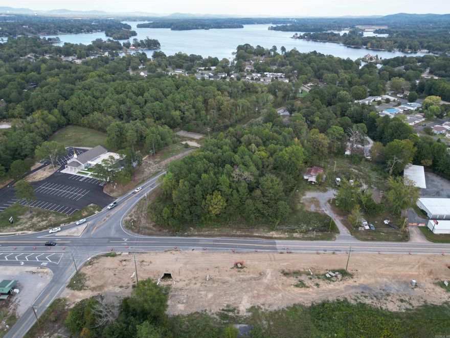 Welcome to an exceptional commercial opportunity located just south of the city limits on Central Avenue (Highway 7 South). This property stretches between the Lake Hamilton bridge and Highway 290, strategically positioned to benefit from a significant highway expansion project, currently under construction, destined to enhance its marketability. Surrounded by a vibrant commercial landscape, this property is in the company of a neighborhood strip center, restaurants, office buildings, a convenience store, Harp’s food store, lakefront residential condominiums, a newly developed subdivision and vacant land tracts ready for development. The diversity of neighboring businesses offers potential synergy and ample opportunities for various enterprises. All essential city utilities and services, including water, sewer, electricity, gas, storm sewer, telephone, and garbage removal, are readily accessible, ensuring a seamless transition for your commercial venture. Ingress and egress are facilitated via Central Avenue, doubling as State Highway 7, ensuring excellent connectivity to the city and surrounding areas.