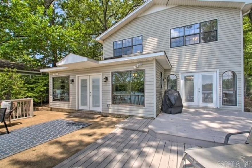 **Stunning Lakefront Home on Lake Hamilton!** Welcome to your dream retreat! This beautifully renovated four-bedroom lakefront home offers a perfect blend of comfort and adventure. Boasting breathtaking views of Lake Hamilton from the spacious kitchen, open living room, and large bedrooms. this property features a large master suite complete with a luxurious walk-in shower and soaking tub. An additional game room currently serves as a cozy bunk room, ideal for hosting friends and family. Enjoy outdoor living at its finest with a beautiful backyard perfect for games or relaxation, along with a fantastic back porch and patio area for entertaining. The community boat dock and scenic park are just a block away, providing easy access to the water, along with private parking and picnic tables for your enjoyment. Located just minutes from Hot Springs yet nestled in the tranquility of the county, this home is currently a successful vacation rental, offering great income potential for the new owner. With granite countertops throughout and excellent lake access, this property is a true gem! Don’t miss your chance to own this slice of paradise!