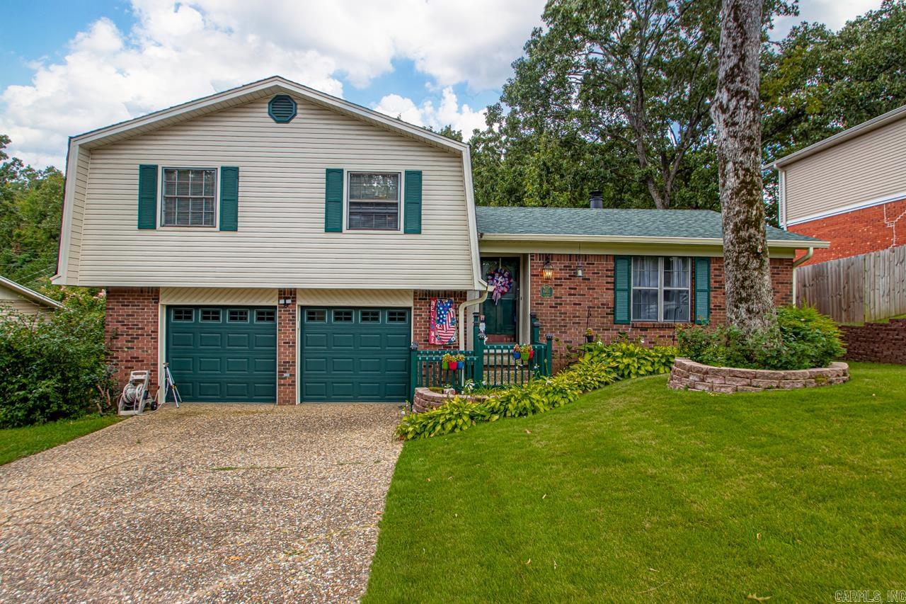 Welcome to this inviting 3 bedroom, 2 bath split level home offering generous living space! The main floor features a layout that is perfect for everyday living or entertaining guests. Upon entering the home you step into the comfortable living room that features a rock fireplace. The spacious kitchen was updated in 2020 to farmhouse style with stainless steel appliances. From the kitchen step into the large sunroom featuring Pella rollout windows and vaulted ceiling. Outside has additional entertaining areas with a partially covered, spacious, multi-level deck overlooking a beautifully landscaped yard that backs up to a green space. Need extra storage, a workshop, or she-shed? The 12x20 Morgan building has electricity and endless possibilities and the 27'x20' garage comes with built in shelving and an alcove for workbench/tools. Laundry room closet lined with cedar. New roof 2022, New upsized hvac 2020, new gutters with leaf guard. Crawl space recently received new vapor barrier, metal doors, vent screens and wells. Paint allowance with acceptable offer.
