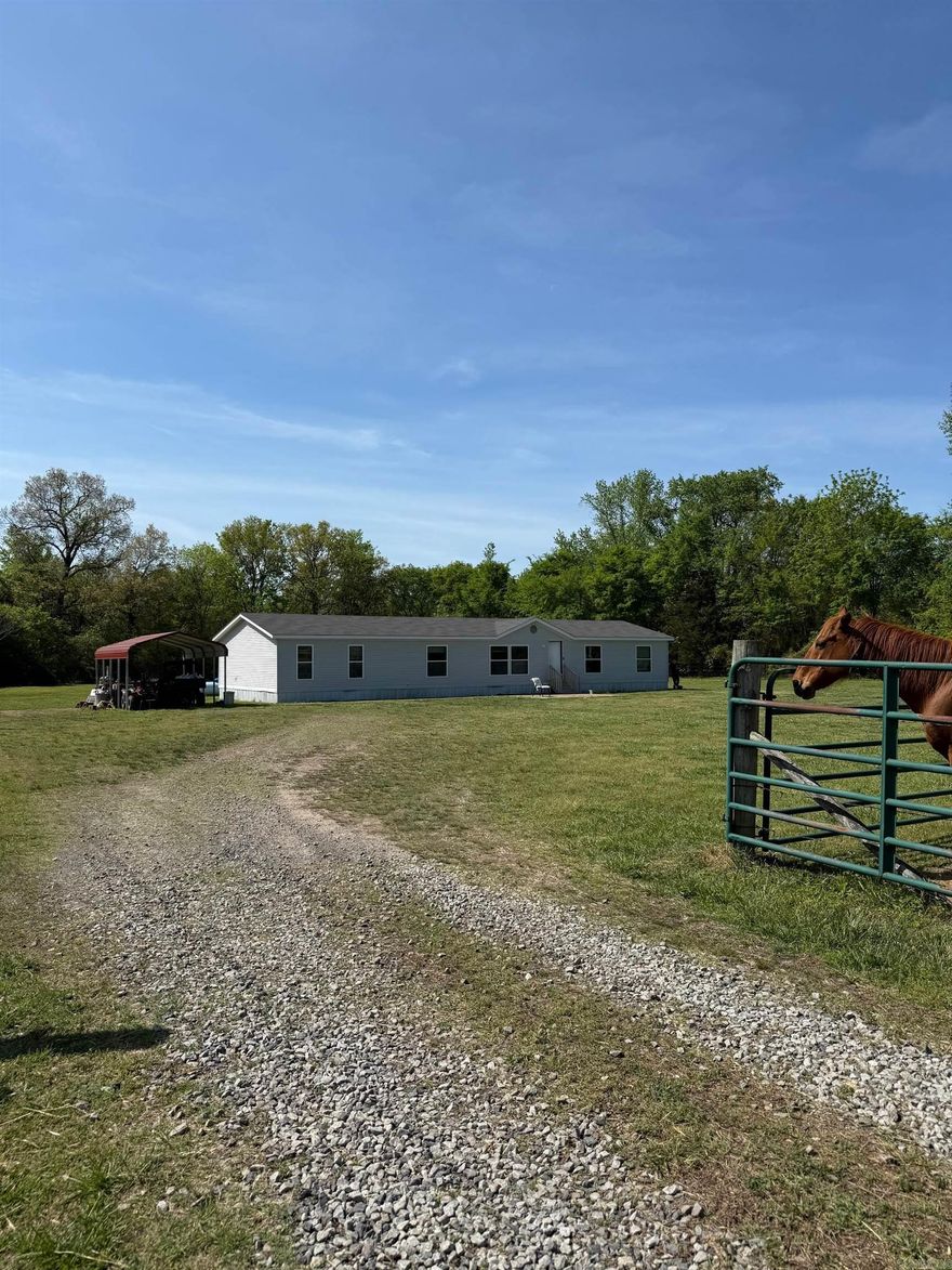Rare opportunity to own 11.23 acres of unrestricted, cross-fenced land in a peaceful country setting. This 4-bedroom, 2-bath double wide offers approximately 2,128 square feet of living space and is ideal for those seeking privacy, room to roam, or a functional homestead setup. Property is well-suited for livestock with existing cross fencing already in place.Home is priced accordingly and offers excellent potential for customization. Cosmetic updates are needed; however, major components have been addressed, including foundation, HVAC system, heating, and water heater—providing peace of mind for future improvements.  Whether you’re an investor, first-time buyer looking for acreage, or someone ready to create their dream rural retreat, this property offers incredible value and flexibility with no restrictions.  Opportunities like this—acreage, usability, and price point—are hard to find. Schedule your showing today.  HOME PASSED FHA INSPECTION/ PERMANENT FOUNDATION- AGENT SEE REMARKS FOR SHOWING