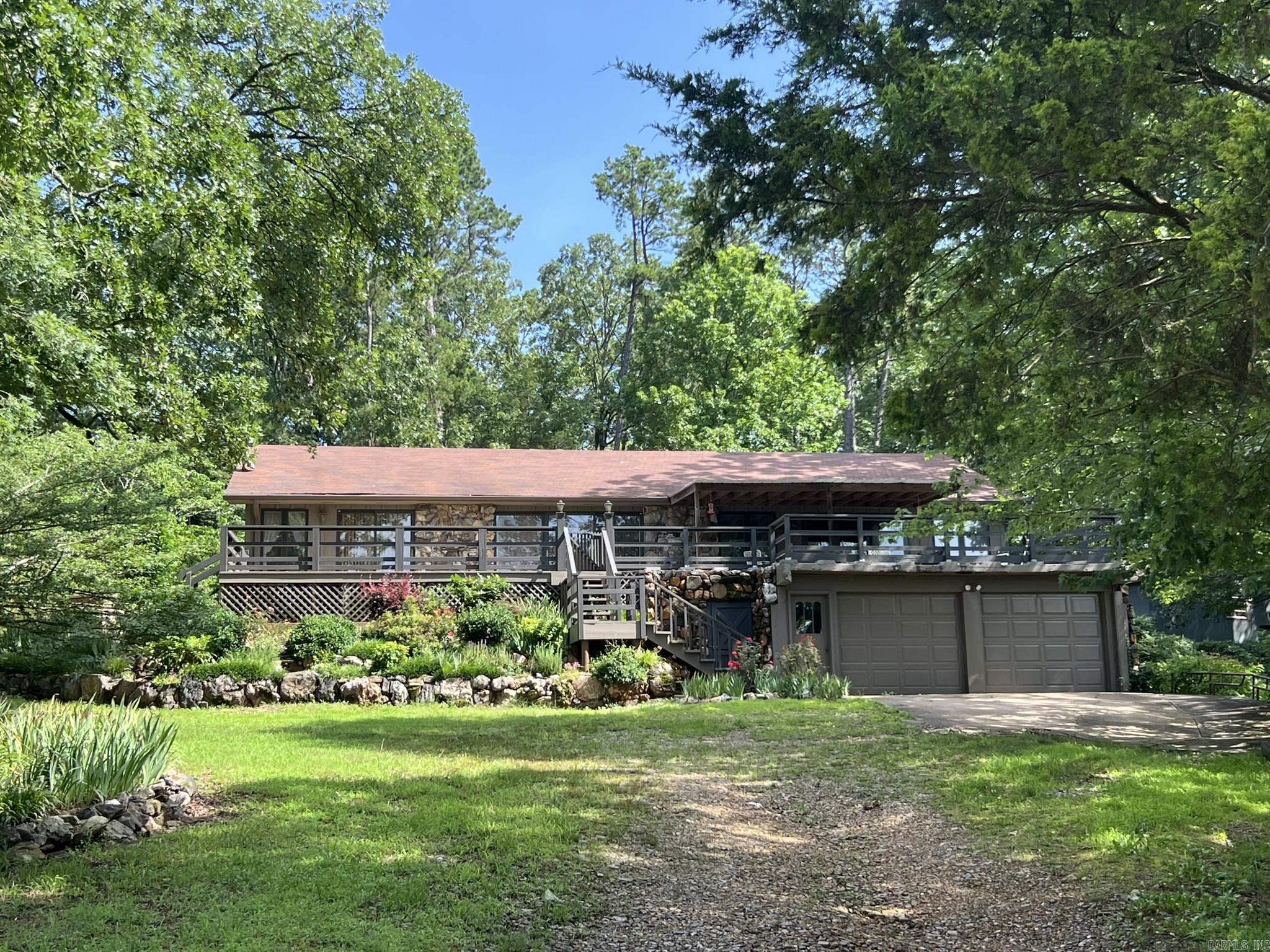 Wonderful home sitting on 83 acres bordering Mill Creek with a pond - this is the retreat you've been looking for! 2608 sf home has large Pella windows and sliding glass doors from three separate rooms leading out onto the deck, which overlooks the neighbors large pond. The kitchen has an expansive island, lots of cabinets and plenty of room for two dining areas. The living room features a double-sided rock fireplace, plus an additional den area. Large bedrooms with lots of closet space offer plenty of room for furniture. Laundry room features lots of cabinets along with a sink. The mud room has an additional entry with even more storage. Travel down to the basement/garage which has loads of potential plus a separate room for your canned goods or just more storage. The deck has plenty of room for lots of furniture, plants, and is perfect for entertaining. The land has two large storage barns, lots of fencing and borders Mill Creek. The northwest portion of the property also has a large pond! So much land with proximity to Wolf Pen Gap trails...the possibilities for further development are endless!