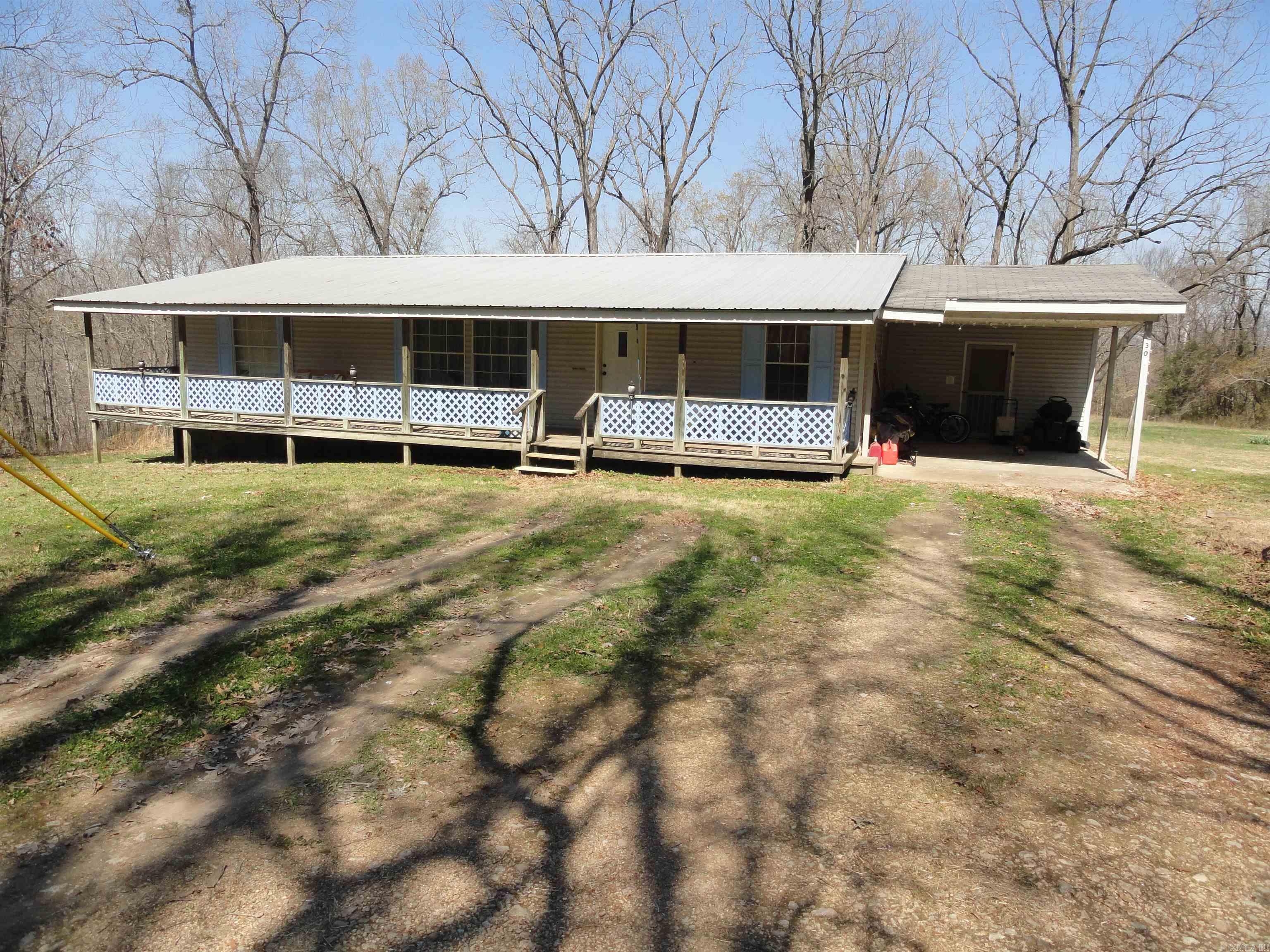 1484 sq foot 3 bed 2 bath double-wide on 1.81 acres M/L with well water & city water available with a water meter already in place but never hooded up because of the good well water. Covered front & back porches, storm cellar, propane tank, carport, huge back yard & large trees. There is plenty of room for planting a large garden & fruit trees and even having a few farm animals with which to have a small homestead. This property is in the country but only 0.35 miles off of a paved county road and 4.3 miles to Hwy 65. The county courthouse is only 5.3 miles away. Most of the amenities that Marshall has to offer is less than 6 miles away. Buffalo National River is 12 miles away where you can hunt, fish, float, camp, swim, hike, explore & ride horses. Harrison 42 miles & Branson, MO 75 miles.