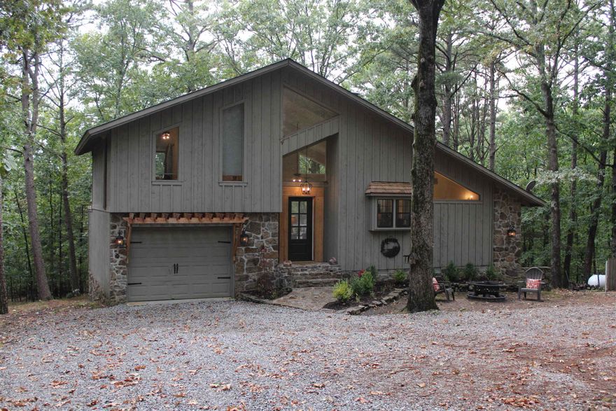 Cozy Cottage in a Wooded Wonderland   Nestled among the trees, this charming 2-bedroom, 2-bathroom cottage offers the perfect blend of comfort and nature. With 1,550 sq ft of living space, the home feels open yet inviting, featuring warm finishes and large windows that frame the peaceful wooded views.  The thoughtfully designed layout includes a welcoming living area, spacious kitchen, and cozy bedrooms; ideal for family, guests, or a weekend retreat. Step outside and you’ll find yourself surrounded by towering trees and natural beauty, making it a true sanctuary away from the hustle and bustle.  Adding to the charm, this property includes its very own private boat slip perfect for enjoying lazy days on the water, fishing, or sunset cruises.  Whether you’re looking for a full-time residence or a relaxing getaway, this woodland cottage is your chance to embrace a simpler, quieter lifestyle.  Come experience the serenity of life in your very own wooded wonderland with lake access at your doorstep!