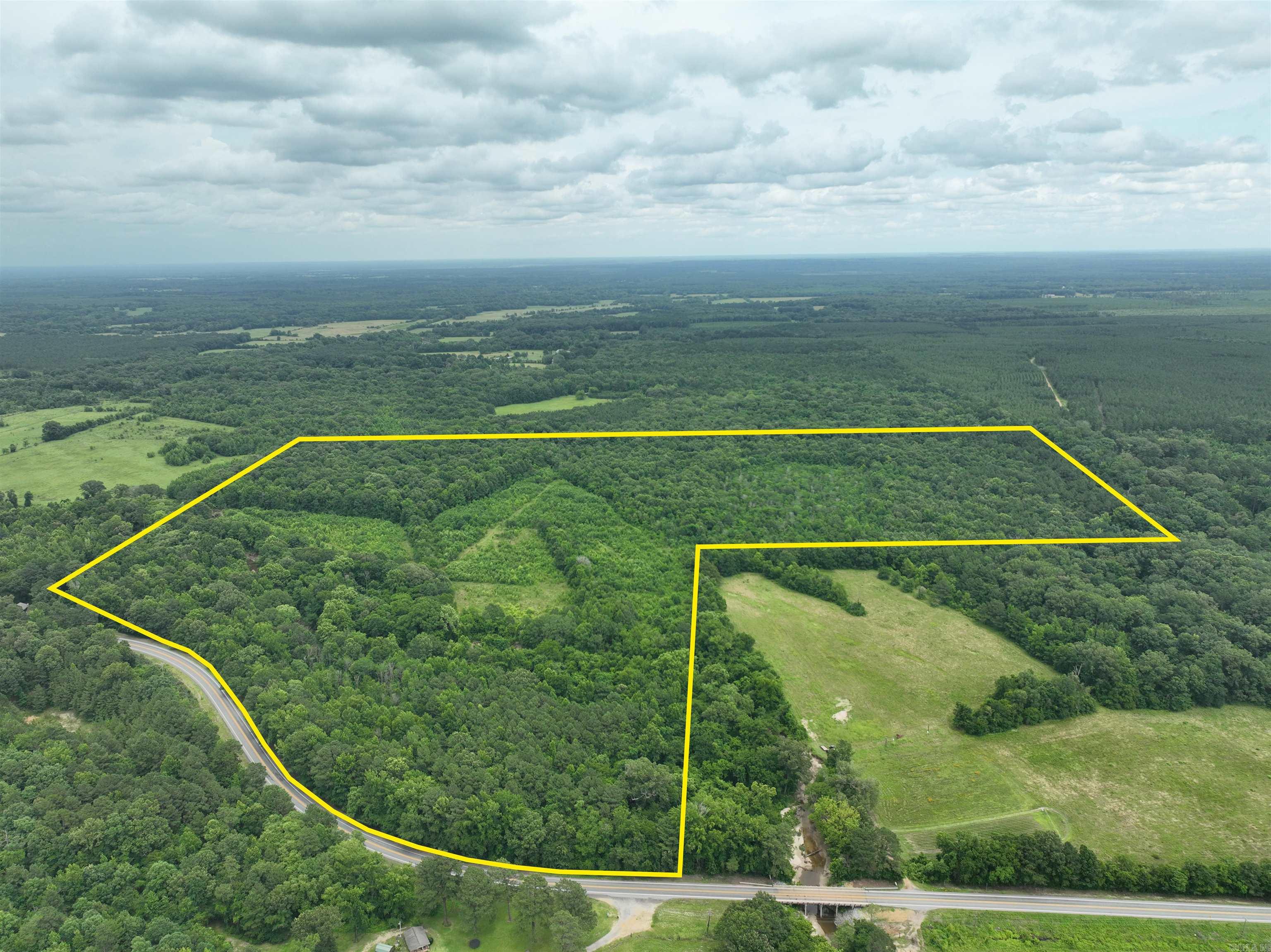 Located in Clark County with direct frontage on Highway 53, this 118-acre property offers a well-rounded mix of timber and naturally regenerated pasture. The South Fork Terre Noire Creek meanders through the land, providing a year-round water source and enhancing its appeal as a wildlife haven. Natural game funnels and multiple food plot locations make it an excellent choice for hunting deer, turkey, and other game species. Beyond its recreational value, the open areas on the property could be reclaimed for hay production or livestock grazing. Whether you’re looking for a secluded hunting tract, or a productive piece of rural ground, this property offers flexibility, access, and natural beauty all in one.