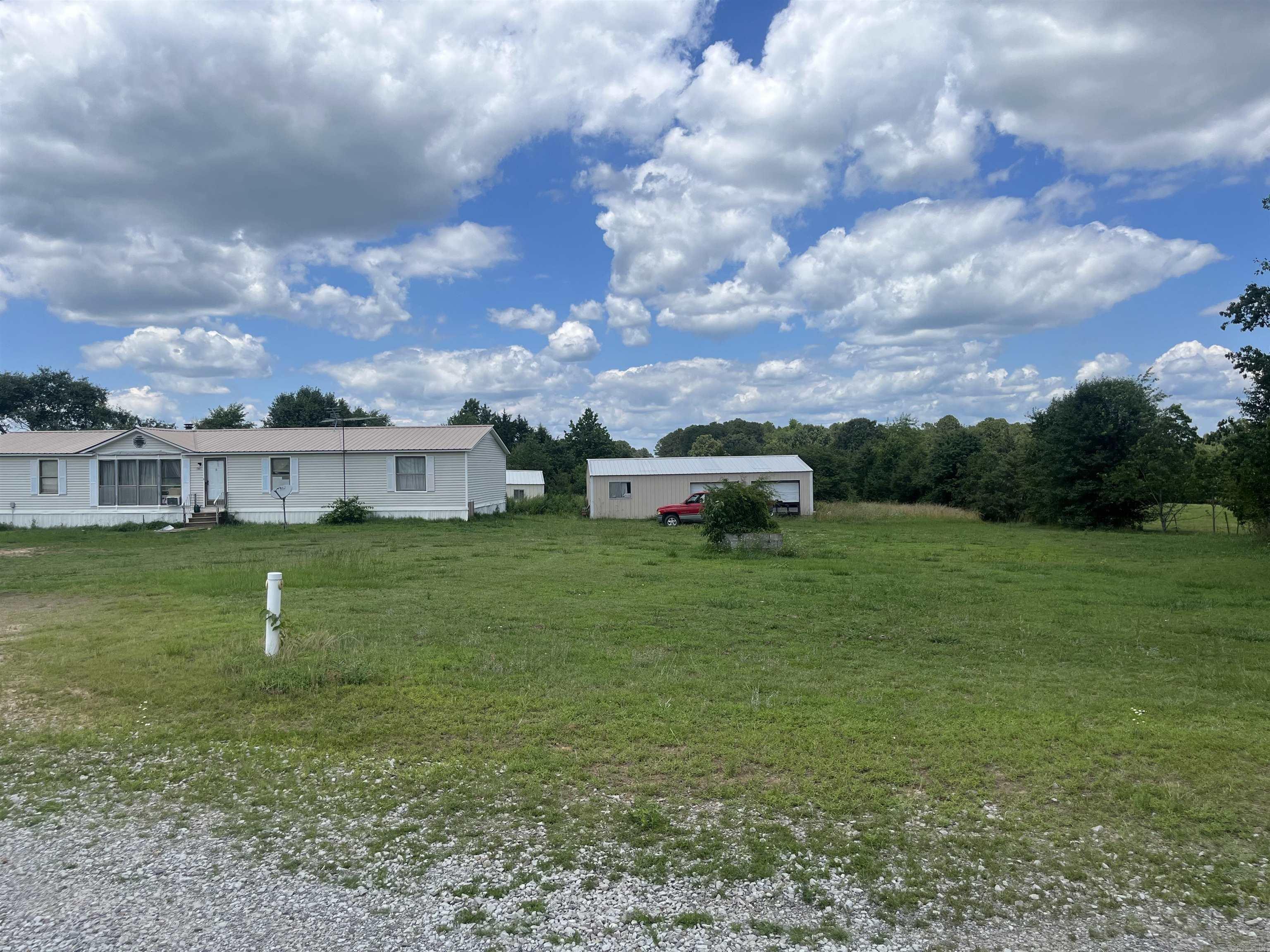Looking for a farm with great pastures and cross fenced? Well here it is! This property is approx 60 acres and has a Double wide mobile home needing some TLC a 20x50 shop a 20x40 metal building and a couple other outbuildings. Mobile home and buildings are as is seller will do no repairs or updates. There is a gas/oil lease on approx 3acres back of property. Mineral rights will convey! There's lots of options with this property. Land is absolutely beautiful!