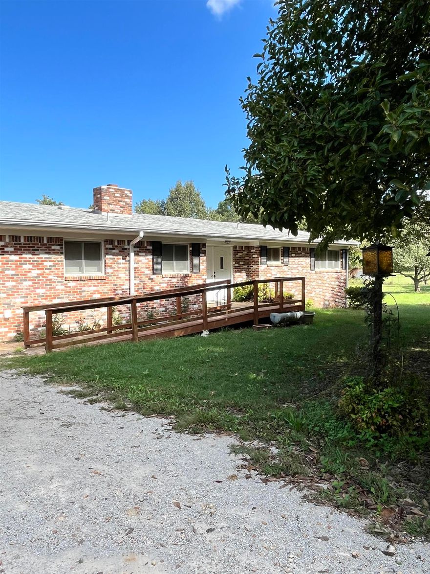 This 2,428 sq ft, 3 bedroom, 2 bath home sits on 4.84 acres and is move-in ready with plenty of potential to make it your own. Step inside to a spacious living room, a large sunroom filled with natural light, and a master suite featuring a garden tub. The kitchen is equipped with stainless steel appliances and granite countertops. Carpet has been recently cleaned, and while the home could use some updates, it offers a solid foundation and a welcoming layout.  Outside, enjoy a covered back patio and the charm of a classic red barn—ideal for storage, hobbies, or livestock. This property is the perfect blend of comfort and country living with space to add your personal touch.