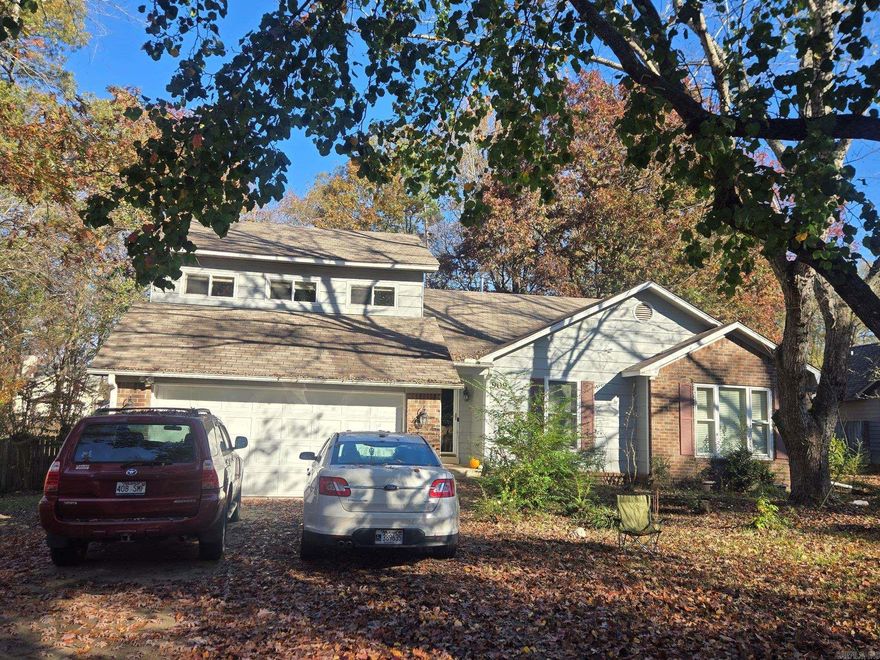 What a find! Large / Well cared for home on a good sized lot in a great location in Bryant.  Home has plenty of space & lots of natural light.  Large back deck over looking your wooded private/fenced oasis. Kitchen w/stainless appliances (all convey), including a gas range! 4 Bedrooms / 2.5 baths. Vaulted great room w/lovely brick gas fireplace. Primary bedroom is also vaulted and primary bathroom has a large corner whirlpool tub, separate shower and dual sink vanity. 4th bedroom is upstairs and could be an office or general bonus space and has a half bathroom attached and a closet. Nice sized laundry room.  Central Heat/Cool less than 10 years old. Attached 2 car garage. Some cosmetic updates are needed, like paint and flooring but home has been priced accordingly.