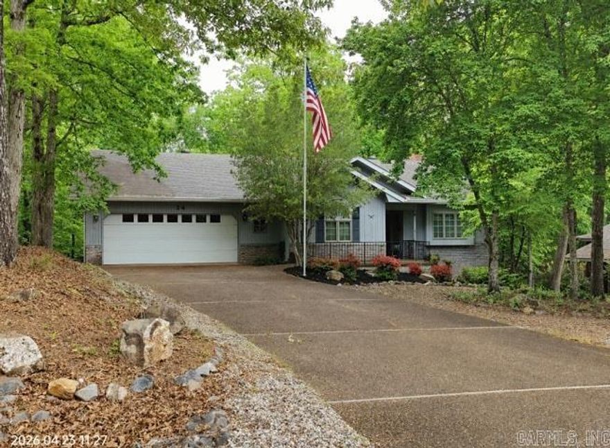Lovely, inviting front welcomes you to an immaculate, well-maintained interior. This three-bedroom, two-bath ranch features a vaulted ceiling in the great room with two skylights, built-in shelving and cabinets surrounding a wood-burning fireplace. The living area opens to a beautiful Arkansas room full of windows and overlooks the woods and fenced yard. The kitchen features built-in double ovens, microwave, granite counters, ceramic backsplash, and pantry. The dining area’s bay window looks out over a beautifully wooded lot. The primary suite boasts two closets, level walk in shower & access to deck. Spacious guest rooms are separate from the primary suite. Conveniently located, the laundry room is just off the kitchen. The oversized garage has a workbench and is large enough to hold your F-150. Handicap-accessible entry doors include a small ramp and doors wide enough for a wheelchair.  The Village is a 26,000-acre gated community with 11 lakes, 9 golf courses, pickle ball, tennis, 40 miles of hiking trails, indoor and outdoor pools, fitness center, two marinas and white sand beach with covered picnic tables, fishing pier, volleyball and playground. .