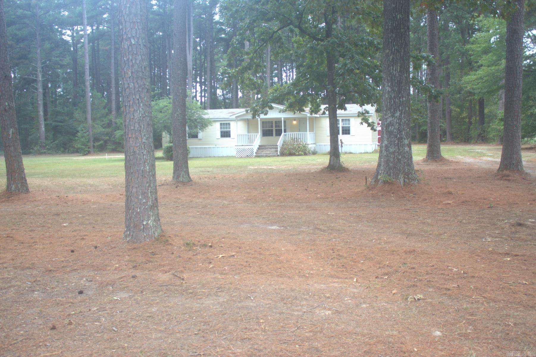 Attention savvy investors and skilled handymen: seize this rare opportunity to transform potential into profit. This permanently attached mobile home with two separate storage sheds, nestled on over four serene acres loaded with tall mature pine trees, is brimming with promise. With a bit of effort, it can become a lucrative rental property or a peaceful personal retreat. Act now—this property is being sold "AS IS WHERE IS," Disclosure is not available and the owners will not be making repairs.