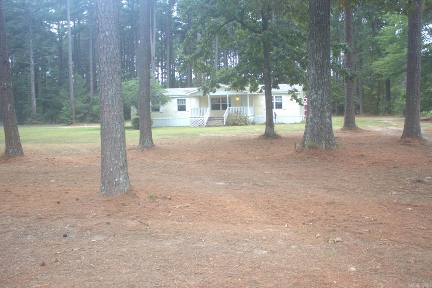 Attention savvy investors and skilled handymen: seize this rare opportunity to transform potential into profit. This permanently attached mobile home with two separate storage sheds, nestled on over four serene acres loaded with tall mature pine trees, is brimming with promise. With a bit of effort, it can become a lucrative rental property or a peaceful personal retreat. Act now—this property is being sold "AS IS WHERE IS," Disclosure is not available and the owners will not be making repairs.