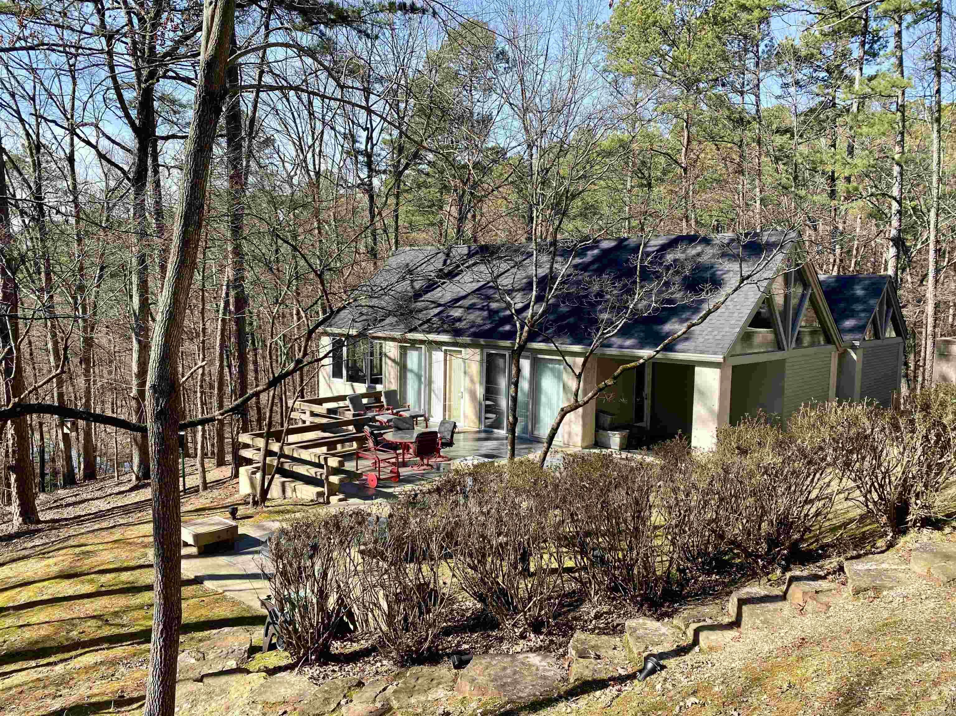 Privacy at Mountain Harbor Resort on Lake Ouachita! 2 residential lots, (approx. 7.49 acres) in the Harbor South subdivision ensures your privacy from all directions AND borders the National Forest! This 2,358 sq.ft. wooded retreat has 2 bedrooms, 2 1/2 baths, extra sleeping in the loft, wood burning fireplace, wet bar, whole home generator, pull through garage and a large concrete patio with fire pit and hot tub. All with views of the forest! 2 separate entrances thru the forest take you to this captivating home and property. Family & friends will enjoy fishing in the small lake that is just down the hill from the home. Whether you are looking for peace and quiet in a forested getaway or want to be close to all the activity that lake living brings this special place has it all. Don't wait, call today to see this rare find at Mountain Harbor.