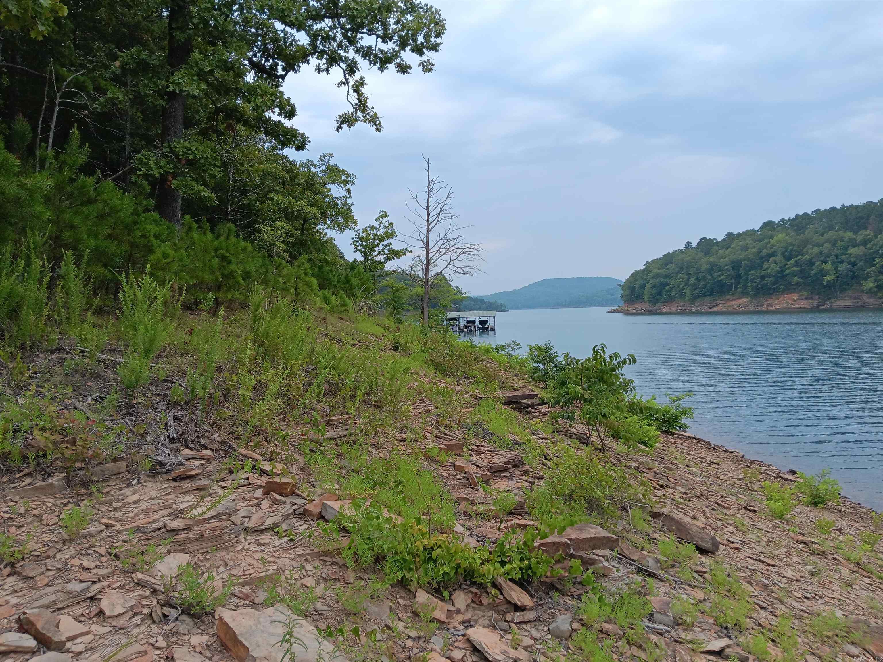 Great lot for building. Lake front. Pictures taken from lake are below the white line. Nice location. Utilities are underground. Mineral rights do not convey. Agent see remarks.