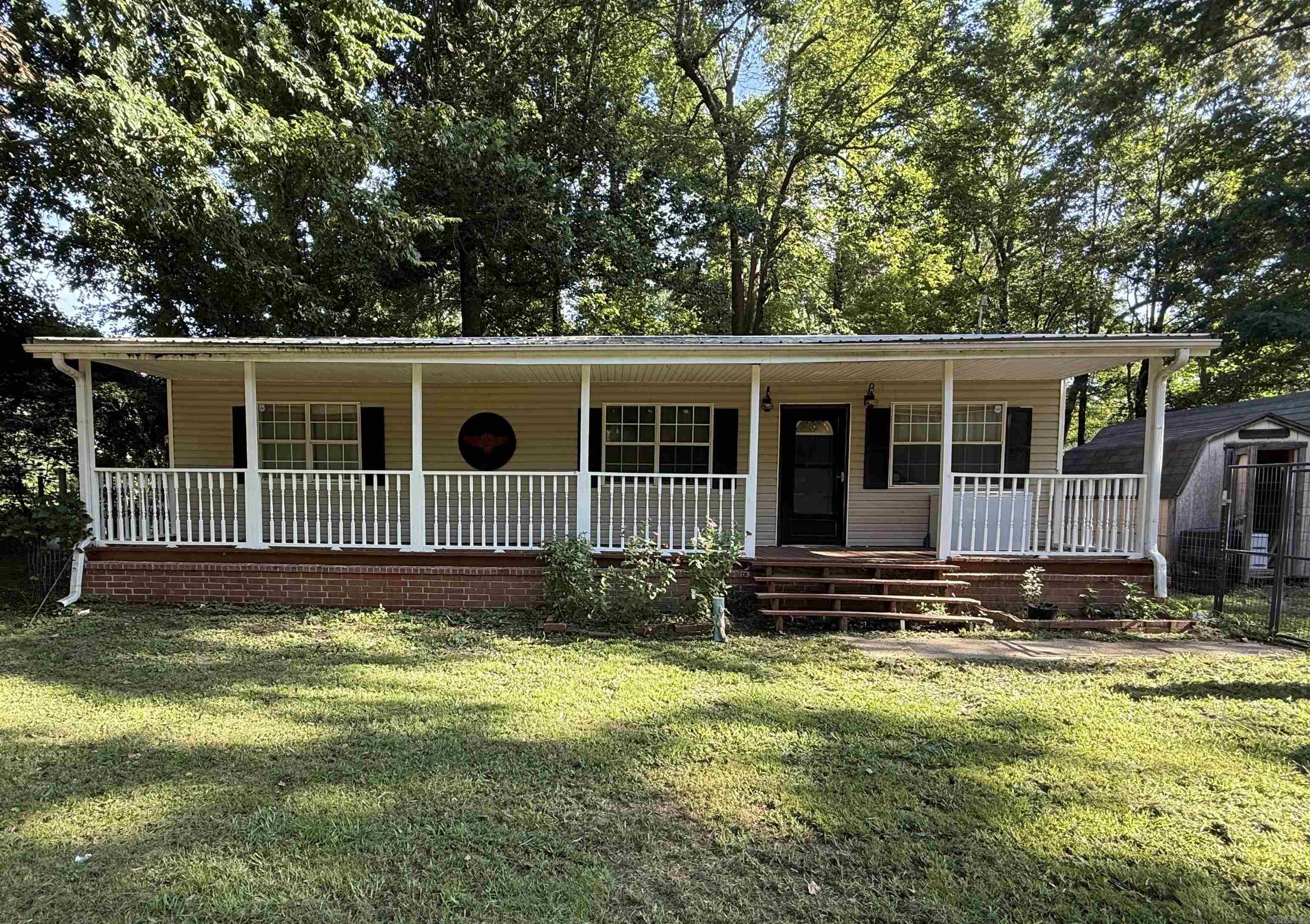 Discover peaceful country living in this charming 3-bedroom, 2-bath home situated on a spacious half-acre lot. With approximately 1,150 square feet of comfortable living space, this property offers the perfect blend of privacy, functionality, and locationājust off Highway 351 and conveniently positioned between Paragould and Jonesboro. Enjoy outdoor living from the oversized covered front porch with railings that span the entire front of the home, or relax out back on the covered deck. The property is fenced with durable metal fencing and includes two outbuildings for storage, hobbies, or workspace needs. Recent updates include a new A/C unit and a metal roof for added peace of mind. Whether you're looking for a starter home, downsizing, or just want a quiet retreat with quick access to town, this one is a must-see!