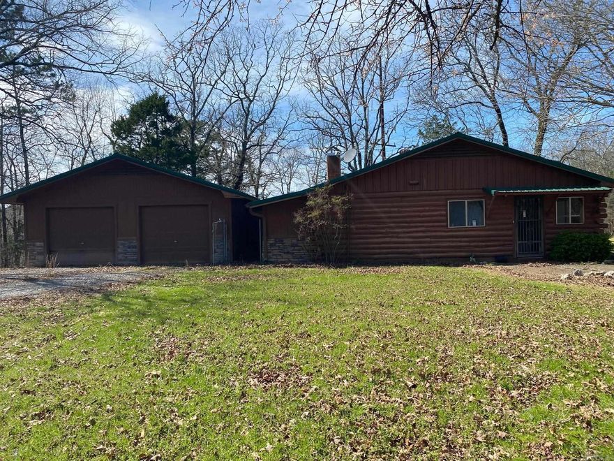 This property is nestled in the Ouachita Mountains close to National Forest, the CMA Headquarters, and trails. The 1490 square foot log cabin has 2 bedrooms, 2 bathrooms and CH/A, with a backup wood stove for heat. The kitchen has lots of counter space and cabinets, perfect for those family get-togethers. The master bathroom has a tub/shower combo. The second bathroom, located off the laundry room, is full-sized with a shower only. The laundry room has a large cabinet perfect for storage, as well as outside access. Home has a generator, with its own propane tank, for back-up power when needed. Property has 3 outbuildings, a large underground storm cellar, and a detached 2 car garage. The views of the mountains can be enjoyed from the home's sunroom as well as the patio. The property also has hook-up for electric and water perfect for a mobile home, or an RV site.
