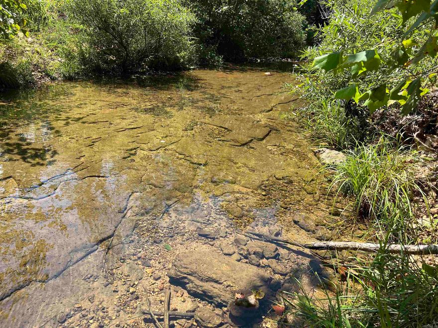 Creek Front Acreage – Mammoth Spring, Arkansas Discover 5 beautiful acres with 512 feet of frontage on Field Creek, offering a rare blend of water access and hilltop views. A level spot along the creek makes the perfect campsite, while higher ground provides ideal home sites overlooking the water. The creek features a solid rock bottom, great for wading and enjoying the outdoors. Wildlife is abundant, making it a hunter’s paradise. Conveniently located just off a county road with electric accessible, this property combines privacy with ease of access. Situated near Mammoth Spring, Arkansas, you’ll be minutes from Mammoth Spring State Park—home to one of the largest natural springs in the U.S.—with year-round fishing, kayaking, and floating on the Spring River. Local dining, shops, and small-town charm add to the appeal, while nearby towns like Hardy, Salem, and Thayer offer even more recreation and amenities. This is the perfect getaway or future homesite for any water lover.