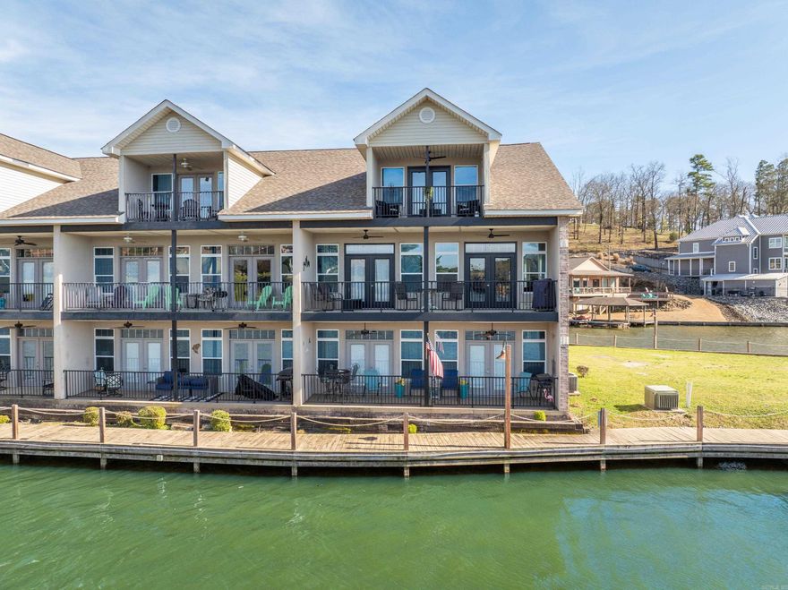 This luxurious, fully furnished Lake Hamilton retreat is not your typical condo. With Four generously-sized bedrooms, Three full bathrooms, 2200+ sq. feet, and an attached garage, this is a rare gem. This condo's prime location as an end unit offers unique privacy and encompassing water views. Situated incredibly close to the water's edge, sparking lake views are offered as your daily backdrop & effortless access to Lake Hamilton's recreation is steps away. Inside, you'll love the expansive floor plan featuring Two primary suites, double private balconies, Two fireplaces. The main level master suite & laundry add to the ease of living, while the upstairs features the additional suite with a kitchenette and an oversized bath. Stroll along the water's edge on the community's extensive boardwalk, or bring your pole and fish straight off the fishing dock. Grand Point does allow nightly-rental usage, offering abundant income-producing potential and enhancing the property value. Whether you're seeking a Primary Residence, Beautiful Vacation Home or income-producing rental, this is a wonderful choice.