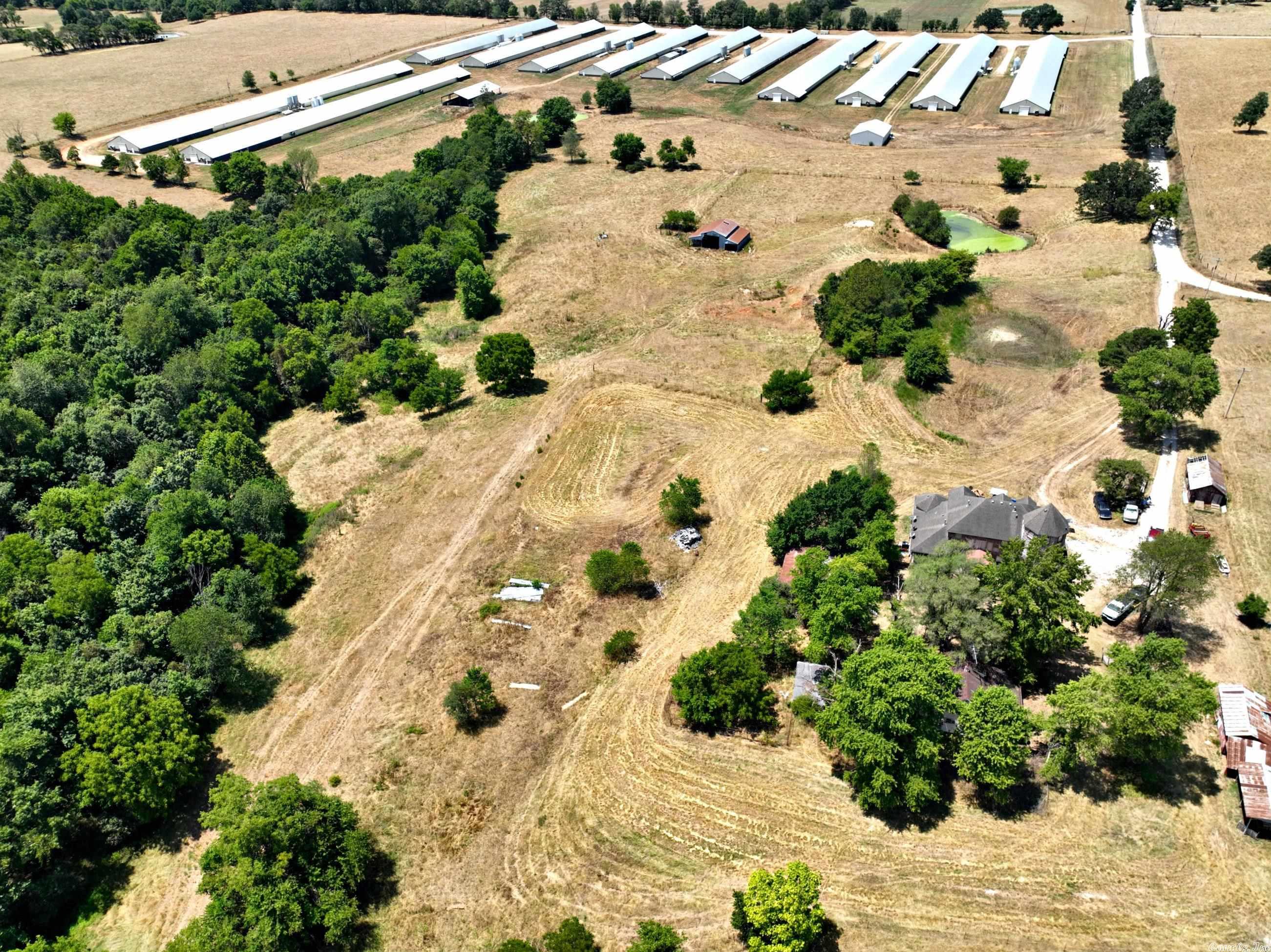 Large, 12 house poultry farm in Northwest Arkansas. Six 55'X600' houses and six 54'X500' houses. Choretronic 2 & 3 electronic systems. Water storage building, litter barn, 4 generators. Current Tyson contract. Cattle barn. Land is fenced and cross fenced for cattle. Large 3,558 square foot home that needs some finishing work. Four bedrooms & 4 baths. Sale includes a T190 New Holland Tractor and other farm equipment. Complete list of amenities on hand. Income/Expense given only w/offer and acceptance.