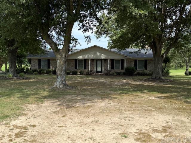 Welcome to your dream home! This charming 3-bedroom, 2-bathroom brick house offers the perfect blend of comfort and nature. Located on 11.8 acres, it provides a serene rural setting with mature trees that offer both beauty, shade and privacy. The home is conveniently located on a paved highway, ensuring easy access while maintaining its tranquil atmosphere. Imagine relaxing on the beautiful patio, where you can enjoy the expansive yard and the peaceful surroundings. The home itself boasts a timeless brick exterior, providing durability and classic appeal. Inside, you'll find a thoughtfully designed layout with spacious rooms that cater to both family life and country living. Roof on the home is approximately 2 years old. Several years ago the roof on the shop was replaced due to a storm that damaged the west section of the shop. The interior walls in that section have not been repaired.