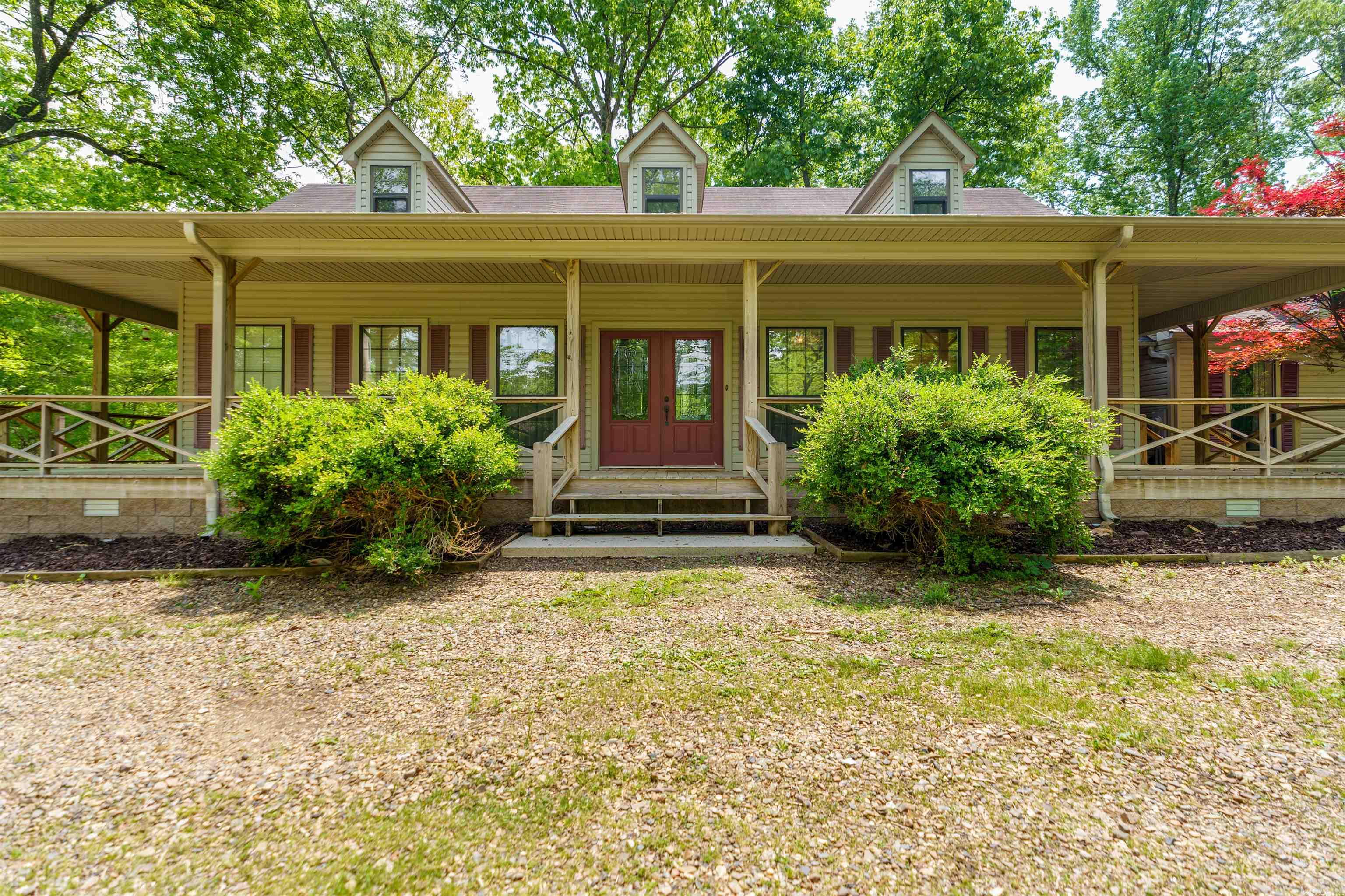 Welcome to your dream homestead! This beautiful 4-bedroom, 3-bath home offers 3,000 sq ft of comfortable living space on a level 7.93-acre property less than 1 mile from Jessieville school. This home is perfect for those seeking space, privacy, and the charm of country living. Step onto the inviting wraparound porch and take in the views of wildlife all around. Inside you'll find two generous living areas, woodburning fireplace, gleaming hardwood floors and a wall of windows to enjoy the natural light. The thoughtfully designed kitchen features granite countertops, stainless steel appliances and a large walk-in pantry. The spacious laundry room could double as a craft room. And don't forget about the drop zone built for convenience and functionality. The property also features an oversized 2 car garage with a separate 3rd ATV garage. Outside you'll find a flowing creek, RV hookup, barn and fencing for livestock, so whether you're starting a hobby farm or simply want wide-open space, this property offers that flexibility and freedom. NEW ROOF 2025! Recent deck repairs have been completed, and the seller is offering a $1,000 credit to put toward painting it to suit your style.