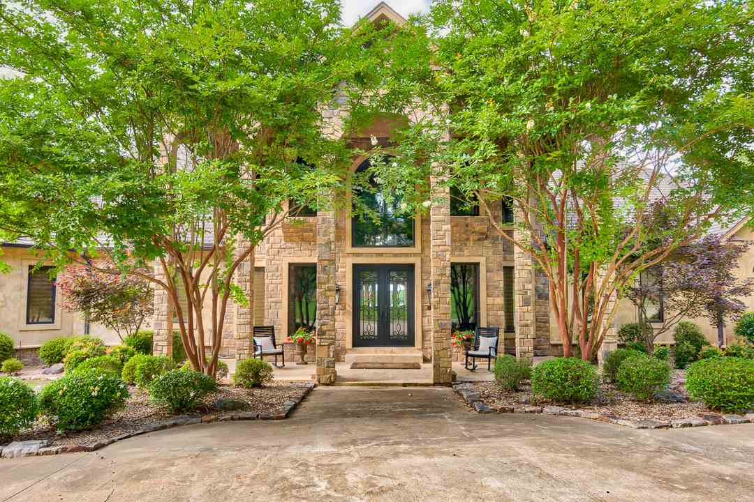 Fall in love with this luxurious lakefront estate in Conway! This home boasts a swimming pool oasis, surrounded with palm trees, a covered boat dock, and a spacious 3.6 acre lot. As you enter the home, you're greeted by dual staircases, 20' ceilings, and views of the lake. The main level features the master suite, a large kitchen with dual islands, an office, and more. The third level features two bedrooms, both with their own private baths, and a theater. The basement features a guest suite and gameroom.
