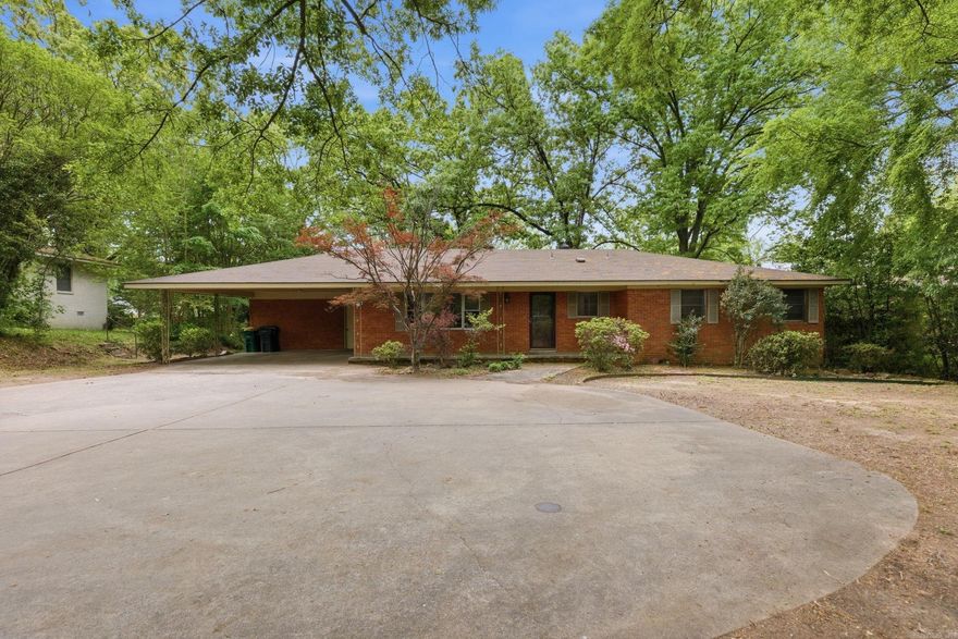 Welcome to this charming home offering the perfect blend of character, updates, and outdoor space. This 3 bedroom, 2 bath property features beautiful original hardwood floors that add warmth and timeless appeal throughout the home, along with spacious, large bedrooms for comfortable living. The interior has also been recently painted, giving the home a fresh and inviting feel. The updated kitchen provides modern convenience, while updated bathroom vanities add a fresh, clean feel. The layout offers flexibility for both everyday living and entertaining. Situated on nearly half an acre, the property boasts an extra-large lot with a landscaped backyard that feels like a private retreat—perfect for relaxing or hosting guests. Additional highlights include a carport plus extra parking pads, as well as a large storage room located just off the carport, offering plenty of space for tools, hobbies, or seasonal items. A new HVAC system and furnace installed in 2025 provide added comfort and peace of mind. Conveniently located near shopping, dining, and major roadways, this home offers both comfort and accessibility. Schedule your showing today!