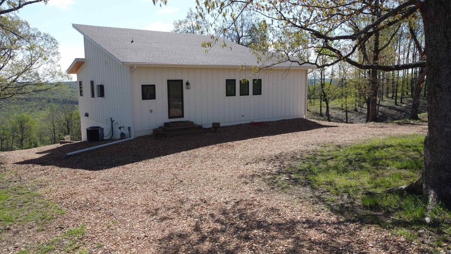 Nestled in the heart of the breathtaking Ozarks! Sitting on 31.97 +/- acres this stunning home the main floor and a full walk-out basement combined totals 2100 sq ft which offers year-round comfort with central heating and cooling. Enjoy 364 sq ft of covered porches perfect for relaxing and taking in the beautiful views of the surrounding hills. Inside, you’ll love the open-concept spacious living space featuring a beautiful kitchen with custom concrete countertops. Primary bedroom is located on the main floor, with a en suite bath featuring cozy heated tile floors. The spacious walk-in shower and thoughtful finishes throughout add both style and comfort. Home is equipped with a transfer switch making it easy to install a whole house generator. The basement area offers a perfect place for guests with a second bedroom located with an en suite bath which also features cozy heated floors and a walk in shower and a soaker tub. Ideal for hobby farmers with pasture ready for livestock/horses. An abundance of wildlife for the avid hunter consists of whitetail deer turkey bear and small game animals. Ample space for your avid gardener. Something to offer for everyone. Don't miss Out!!!