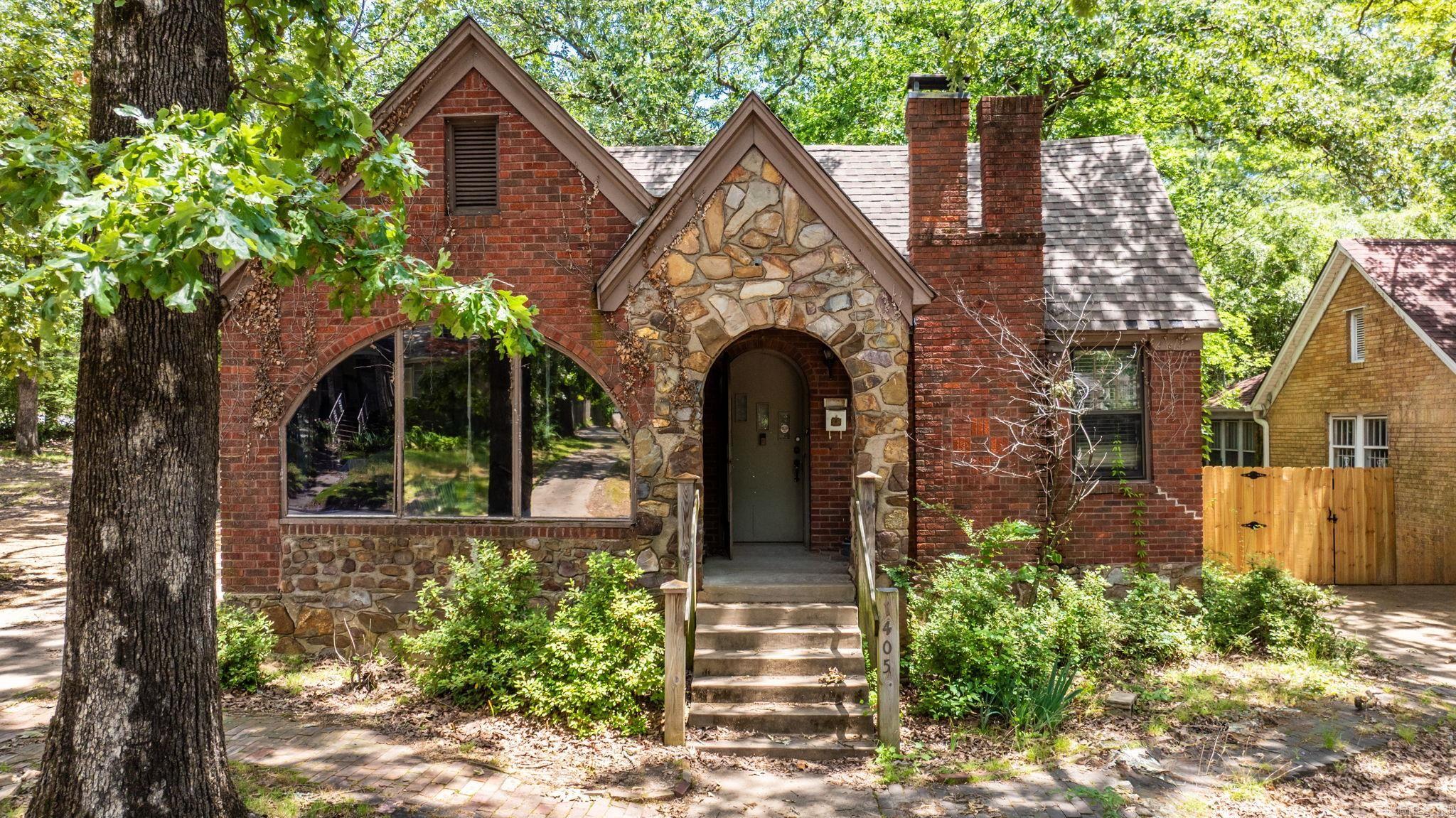 Unique Opportunity in the Heart of Little Rock! Spacious 2 bed, 2.5 bath home with 1,614 sq ft of versatile living space. This property features two kitchens, two dining areas, and two living rooms—ideal for multi-generational living or a potential duplex conversion. Enjoy the charm of a sunroom, cozy up by the fireplace, and take advantage of the 24x18 detached garage for additional storage or workshop space. Situated on a corner lot (included with purchase) and surrounded by a privacy fence, this property offers both space and privacy. Located just minutes from the Little Rock Zoo, War Memorial Stadium, and other local amenities. Sold as-is—bring your vision and make it your own!