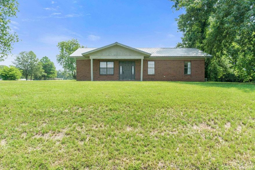 This is the kind of place you’ve been hoping would pop up! Tucked outside the city limits, this property gives you the space to slow down and breathe a little deeper.  This property offers nearly 2 acres of open land, a large carport for parking, 40x50 shop, and pond access! This 1,363 square foot 3-bedroom, 2-bathroom home is ready for you to make it YOURS! Built on a slab foundation with a metal roof that’s only 3–4 years old, you'll have peace of mind for the future. Inside, you’ll find a layout that makes everyday living simple and comfortable. The kitchen has ample counter and cabinet space. Get ready to cook family meals in this large, super functional kitchen. The living space is extremely spacious.  The laundry room is very spacious with an exterior door leading to the back yard. The 40x50 shop is a true dream! Whether you’re into cars, woodworking, or just need room to store your toys and tools, there’s no shortage of space here. And the best part? You’ll own a portion of the pond by the shop, giving you your very own spot to fish and unwind whenever the mood strikes.  This one really do check all of the boxes... space, freedom, function, and the charm of country living!