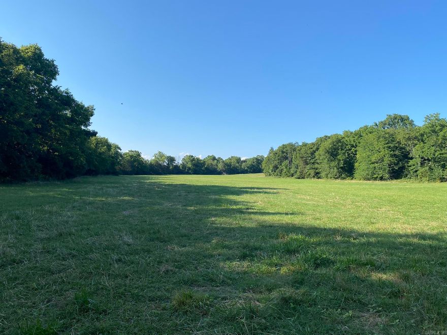 Land like this only comes up for sale every so often in this part of north-central Arkansas. Only an hour from Jonesboro, AR, and a little more than 2 hours from Memphis, TN, this 75 +/- acre property is just a short drive from the city! It is only a quarter mile from Big Creek, known by the locals as the fishing and kayaking gem of Sharp County. The Spring River and South Fork River are as little as a 20-min drive away, offering great floating, as well as trout and smallmouth bass fishing, from all over AR and surrounding states. Hunting on this property offers an extremely unique opportunity. In the NE corner is a high ridge, and in that northernmost corner is the border of Harold E. Alexander Wildlife Management Area. This same ridge system runs North to South and provides perfect habitat for white-tailed deer, turkeys, and black bears. A variety of oak trees cover the landscape, with the occasional pine and cedar trees. If cattle farming comes to mind when seeing the mixed grass pasture, then this is the place for you! It could comfortably handle a couple dozen head of cattle and still have room for more. Additionally, there’s city water and electricity at the road. $297,000!