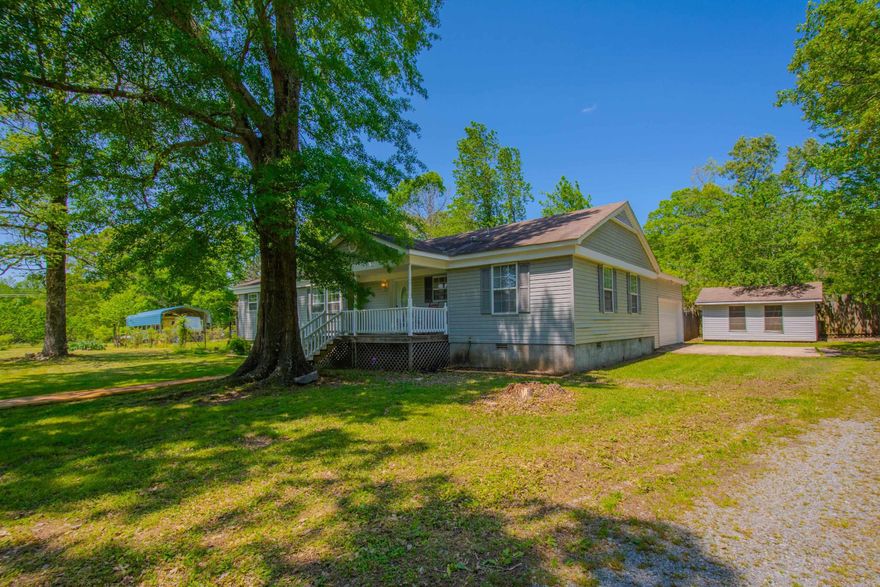 WORKING FARM ON 4 ACRES. 3 bedroom 2 bath home with large rooms.  Kitchen and one bath have been updated.  Large closets. Deck off the dining area.  Privacy fence in rear. Clean and move-in ready. House sets off the road for privacy.  Apple and Peach trees.  Muscadines.  Blueberries and strawberries.  Laying hens can stay. Rv and RV cover and boat cover do not convey and will be moved. Primary bed and bath and garage were built in 2008. Seller does not know the age of the original house. Good, level land outside the city limits.
