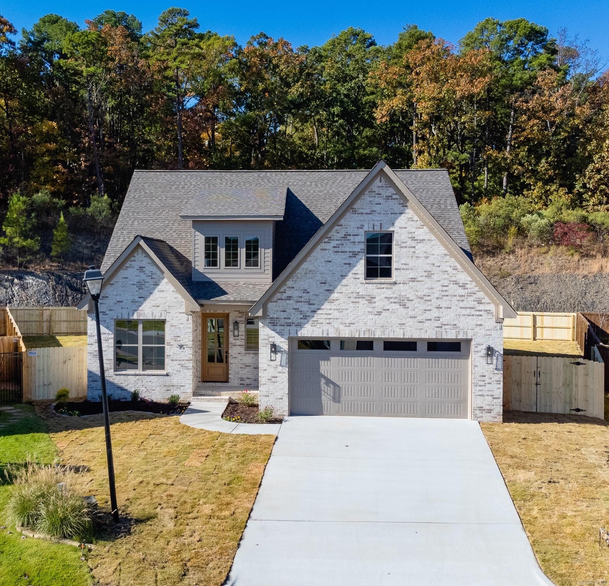 Quality abounds new construction located on level lot with a backdrop of nature and rock cliff guaranteeing privacy and serenity. Stunning 2 story foyer entrance with versatile floor plan. French door office with connecting half bath. Chef's kitchen - large kitchen island, breakfast bar, 5 gas burner cooktop, GE stainless appliances, soft close drawers, large pantry, under cabinet lighting - quartz countertops. Cozy floor to ceiling stone gas log fireplace, exposed ceiling beams and abundant storage. LVP flooring for durability, spacious laundry with built-ins and folding area, tankless water heater. Primary bath has soaker tub, floor lighting and seamless glass shower. Upstairs are 2 or 3 bedrooms with game room, Jack and Jill bath, and attic storage. Covered patio, sprinkler system, gas hood-up for grill, outdoor plug for TV. 24' deep garage. Subdivision nearly completed - conveniently located! See agent remarks.