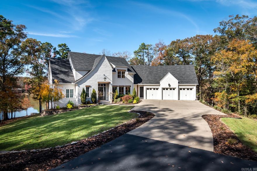 Stunning family home just minutes outside the Little Rock city limits nestled into a private, gated neighborhood surrounded by gorgeous trees and nature at its best. The 3+ acre home site offers stunning architecture custom built by Bill Parkinson with beautiful interior design. The main level features a den (which could be used as an office or formal dining room), gourmet chef's kitchen with Fisher Paykel appliances open to the vaulted great room, half bath and a beautiful primary bedroom suite. Upstairs offers three bedrooms with two full bathrooms and walk-in closets. A den and half bathroom are located on the lower level with access to the backyard. An incredible backyard was designed with a spacious deck overlooking the fully stocked 2+ acre pond.  Other features include foam insulation, high efficiency heating and air conditioners, Andersen windows, generator plus much more!